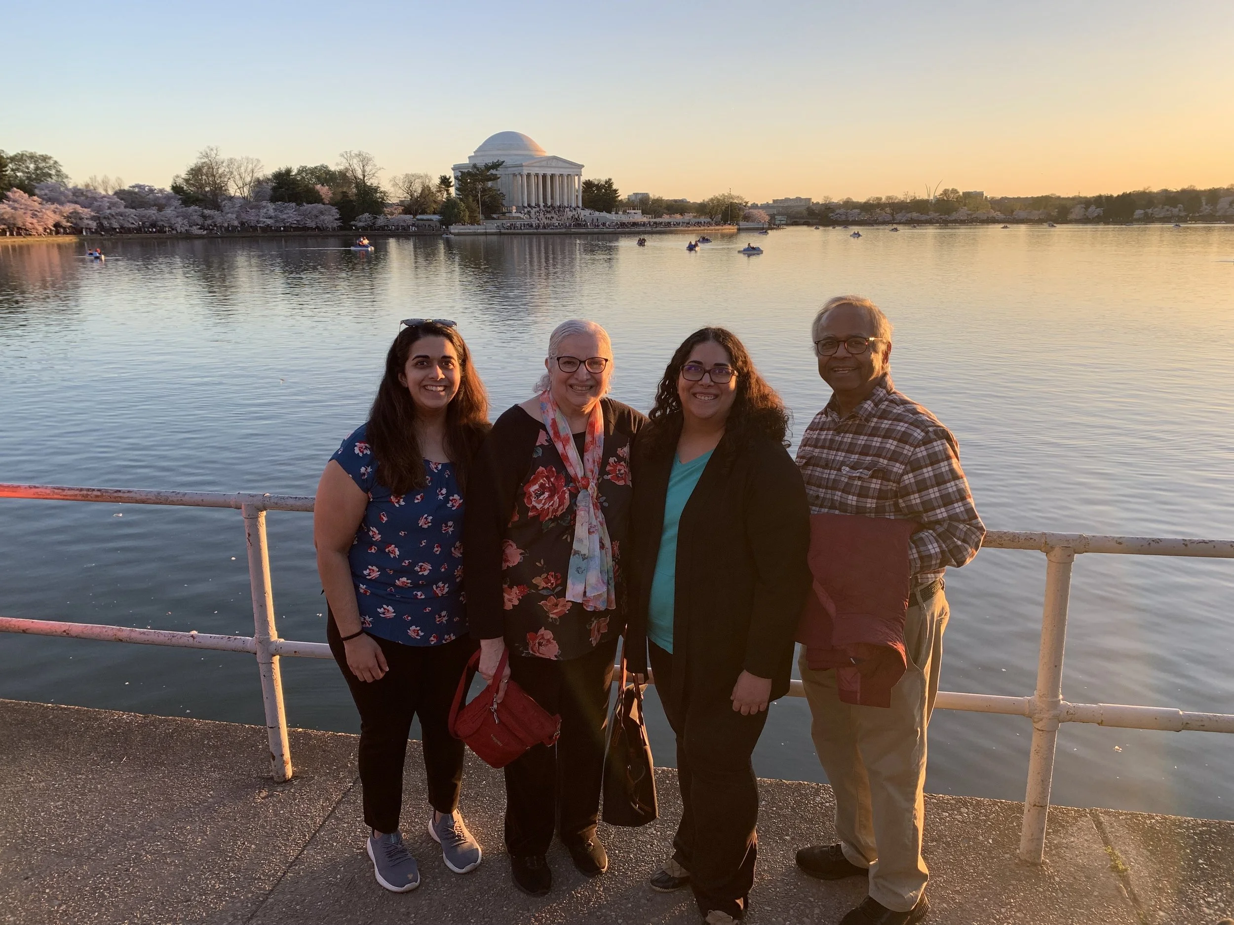 Candidate's family standing near a waterfront with the Jefferson Memorial in the background during sunset.
