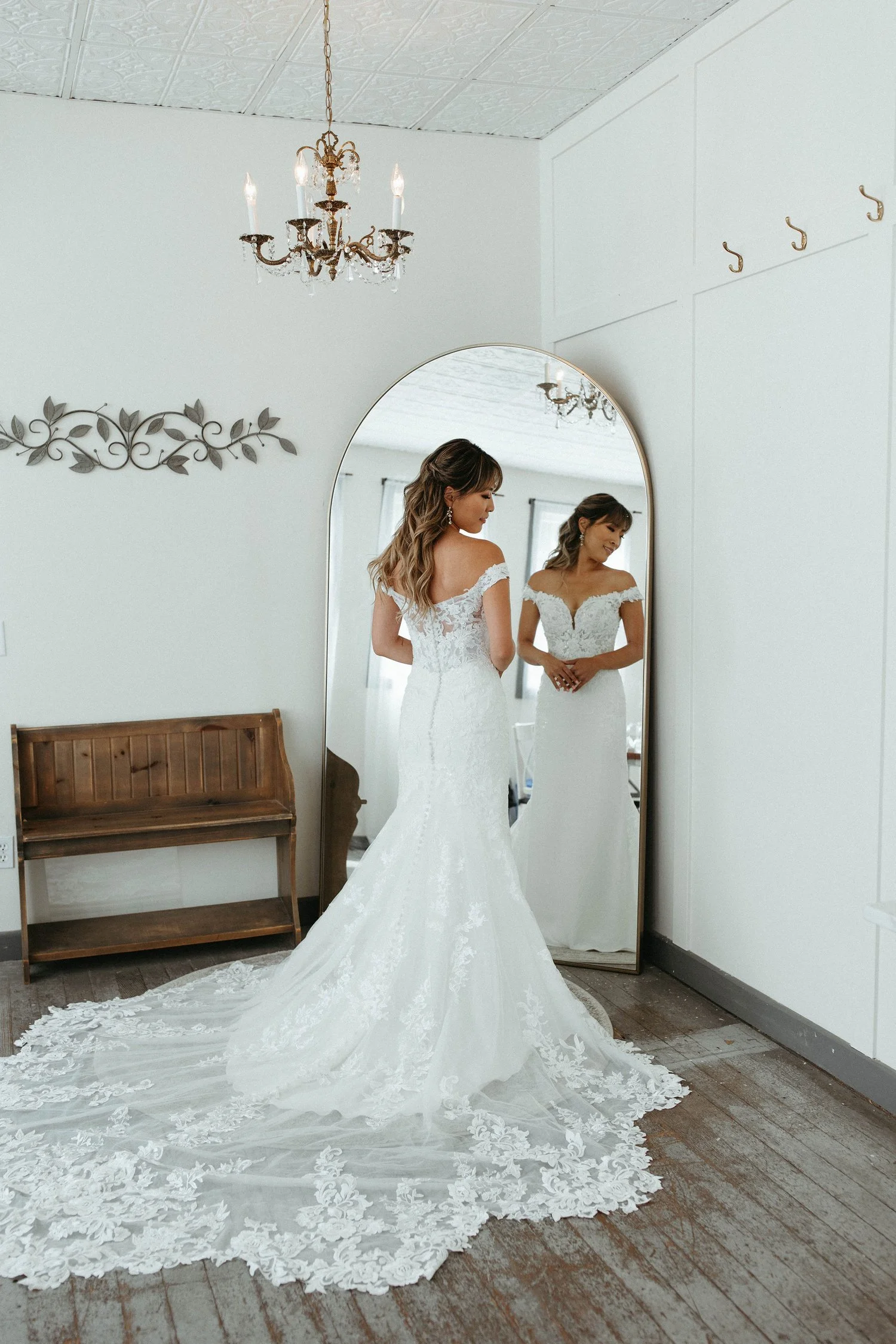 Bridal getting ready space at Pine and Pond with chandelier, dresses, and soft natural light