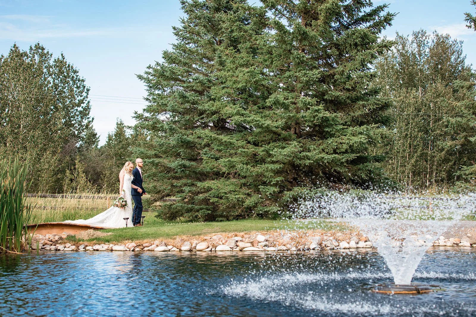 pine-and-pond-wedding-couple-pond-fountain.jpg