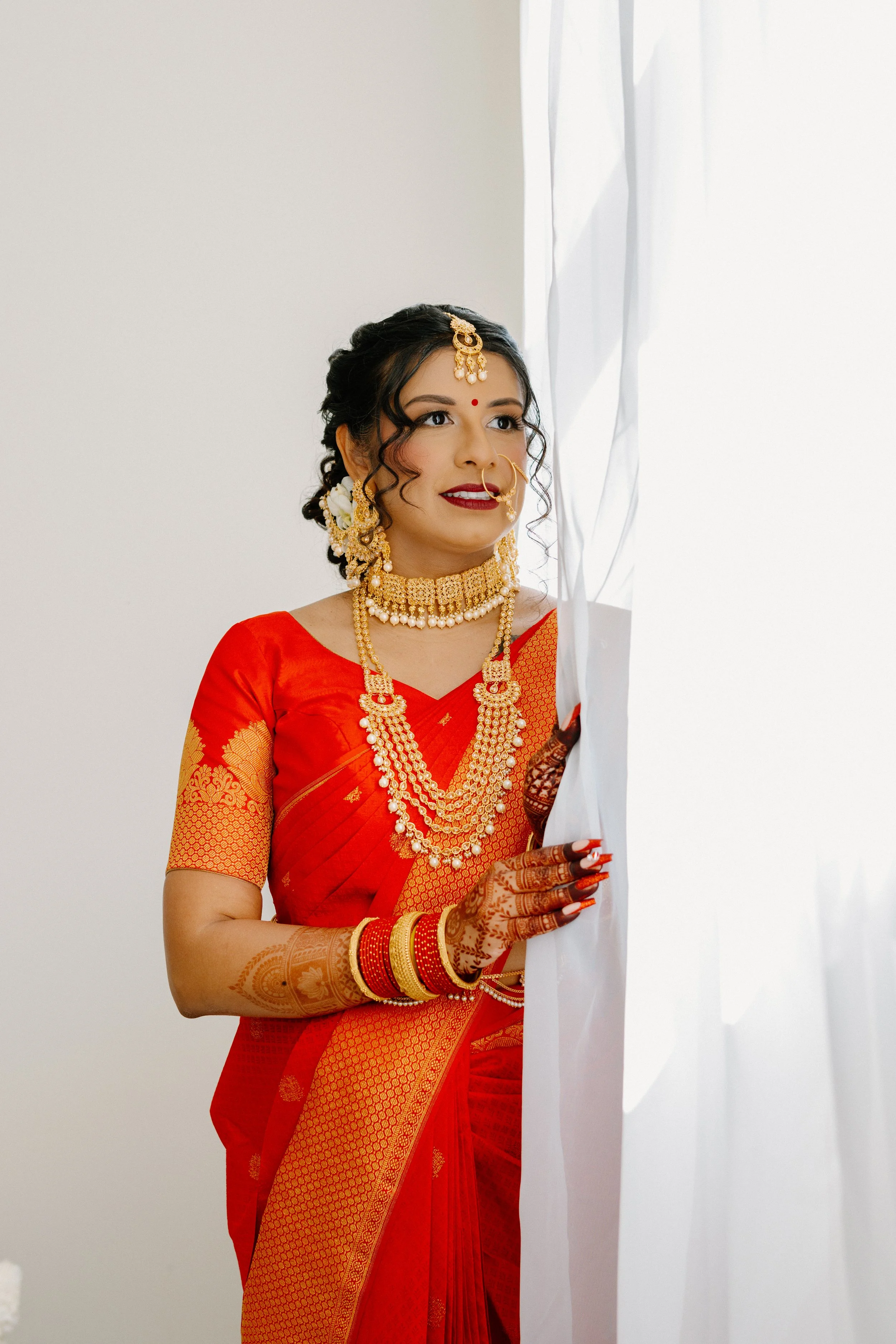 south-asian-bride-portrait-traditional-red-sari-indoor-wedding.jpg