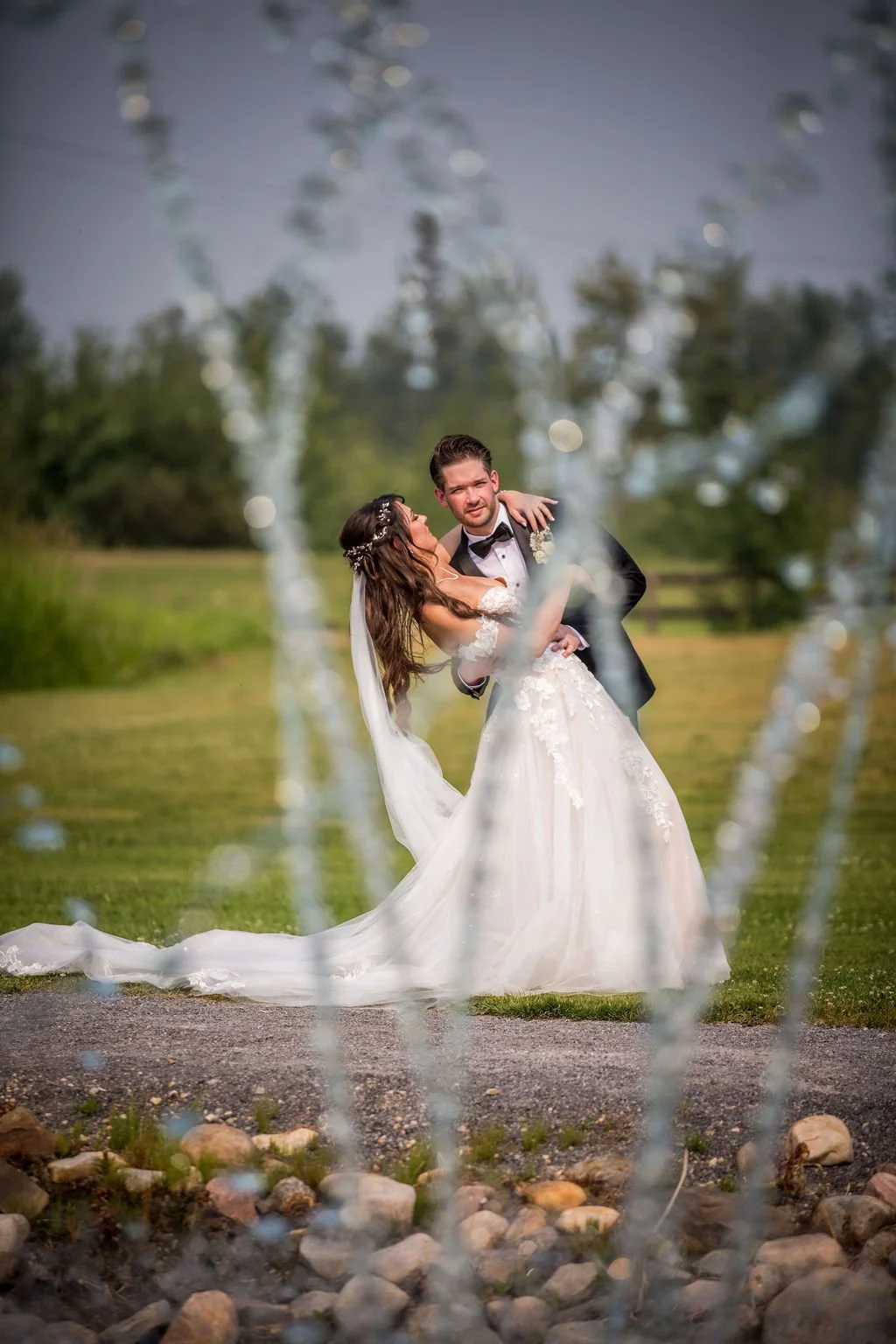 romantic-wedding-couple-dancing-through-fountain-outdoor-venue.jpg