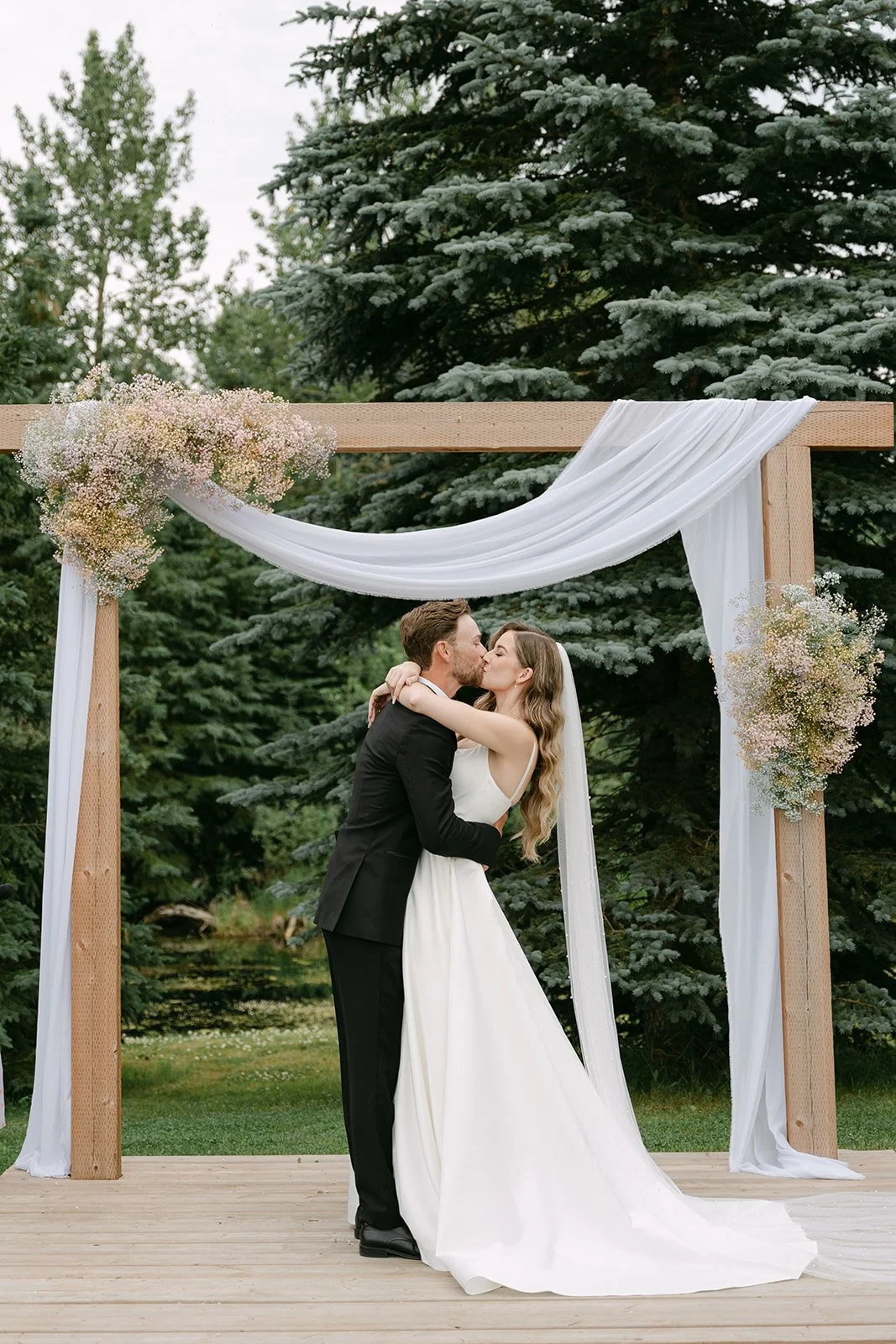wedding-ceremony-arbor-first-kiss-outdoor-venue.jpg
