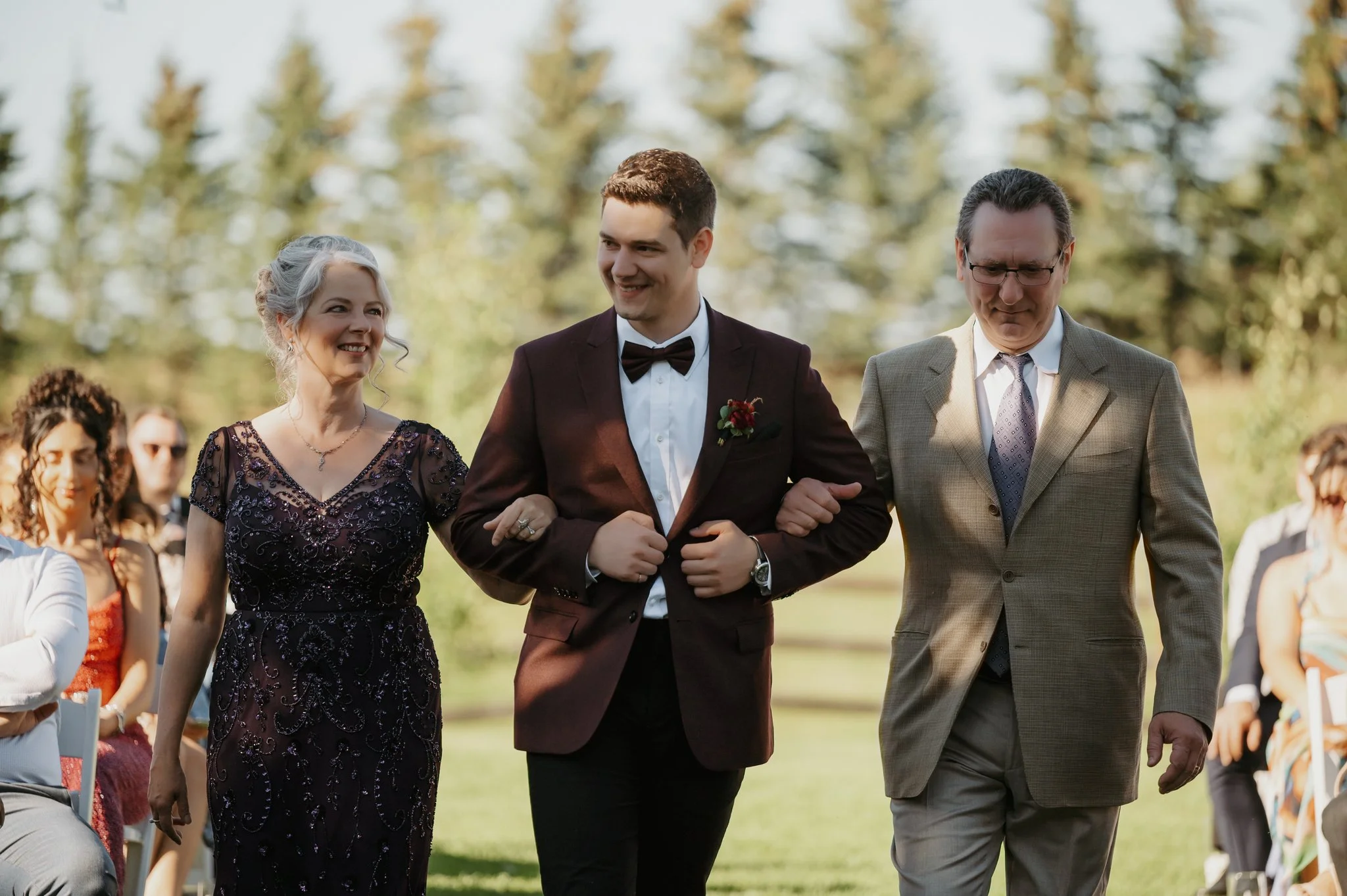 outdoor-wedding-ceremony-groom-parents-aisle-central-alberta.jpg