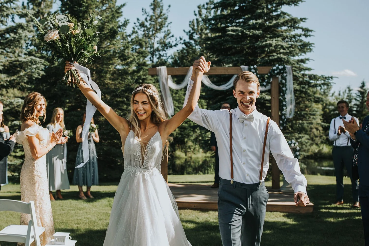 Bride and groom celebrating as they walk back down the aisle after their ceremony at Pine and Pond