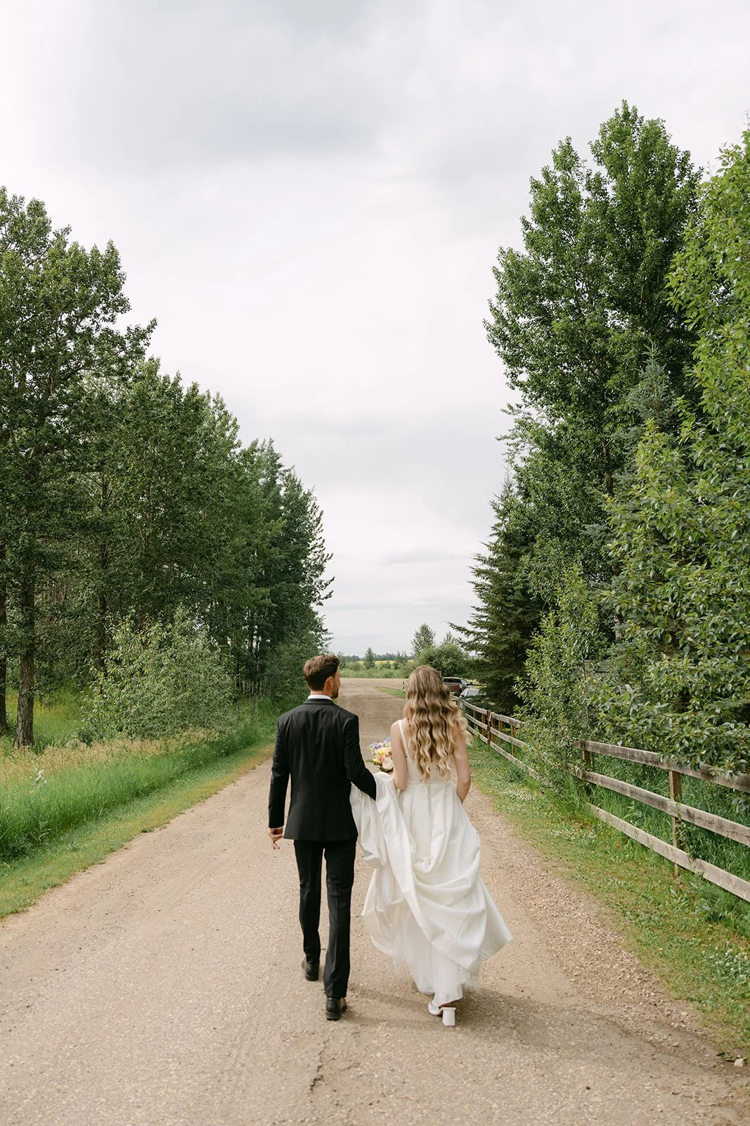 bride-and-groom-walking-country-road-outdoor-wedding.jpg