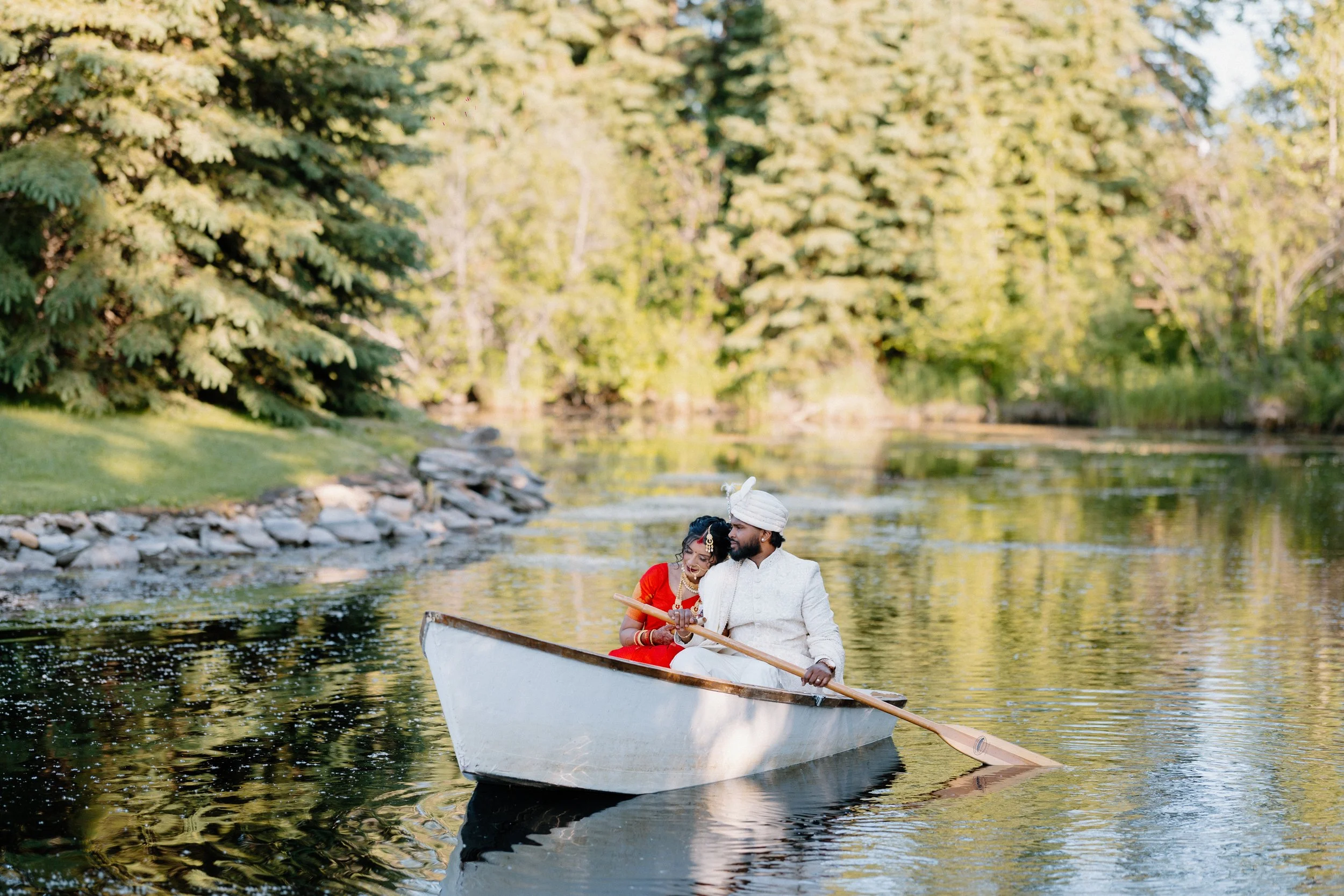 south-asian-wedding-couple-rowboat-pond-outdoor-venue.jpg
