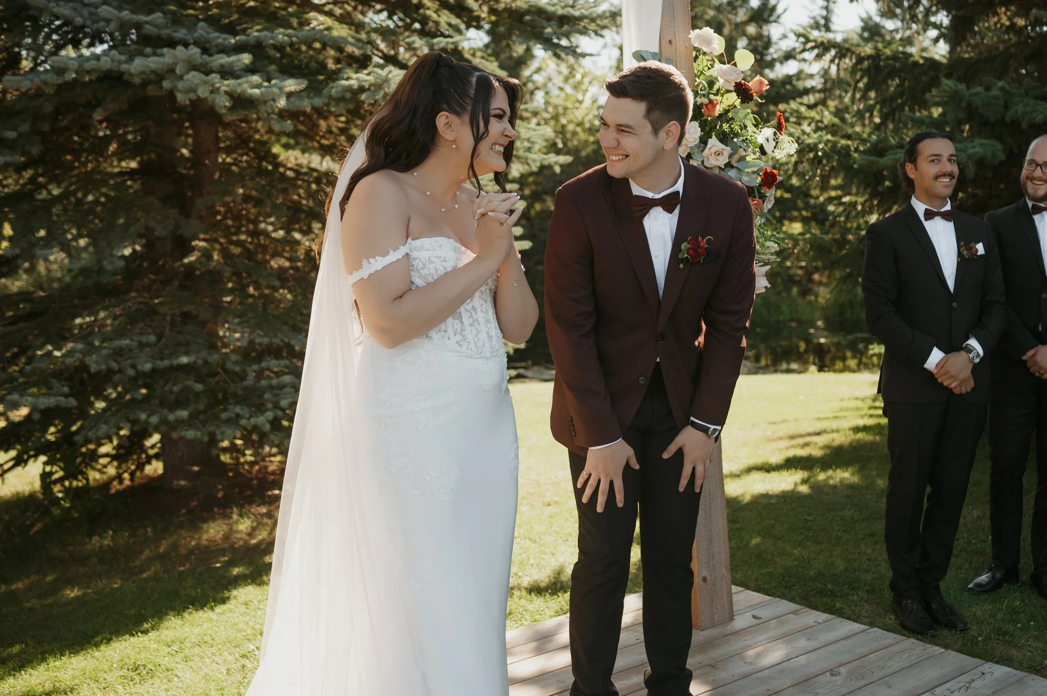 outdoor-wedding-ceremony-couple-laughing-central-alberta-venue.jpg