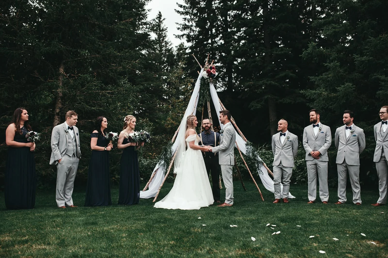 Outdoor forest wedding ceremony with the bridal party at Pine and Pond Wedding Venue
