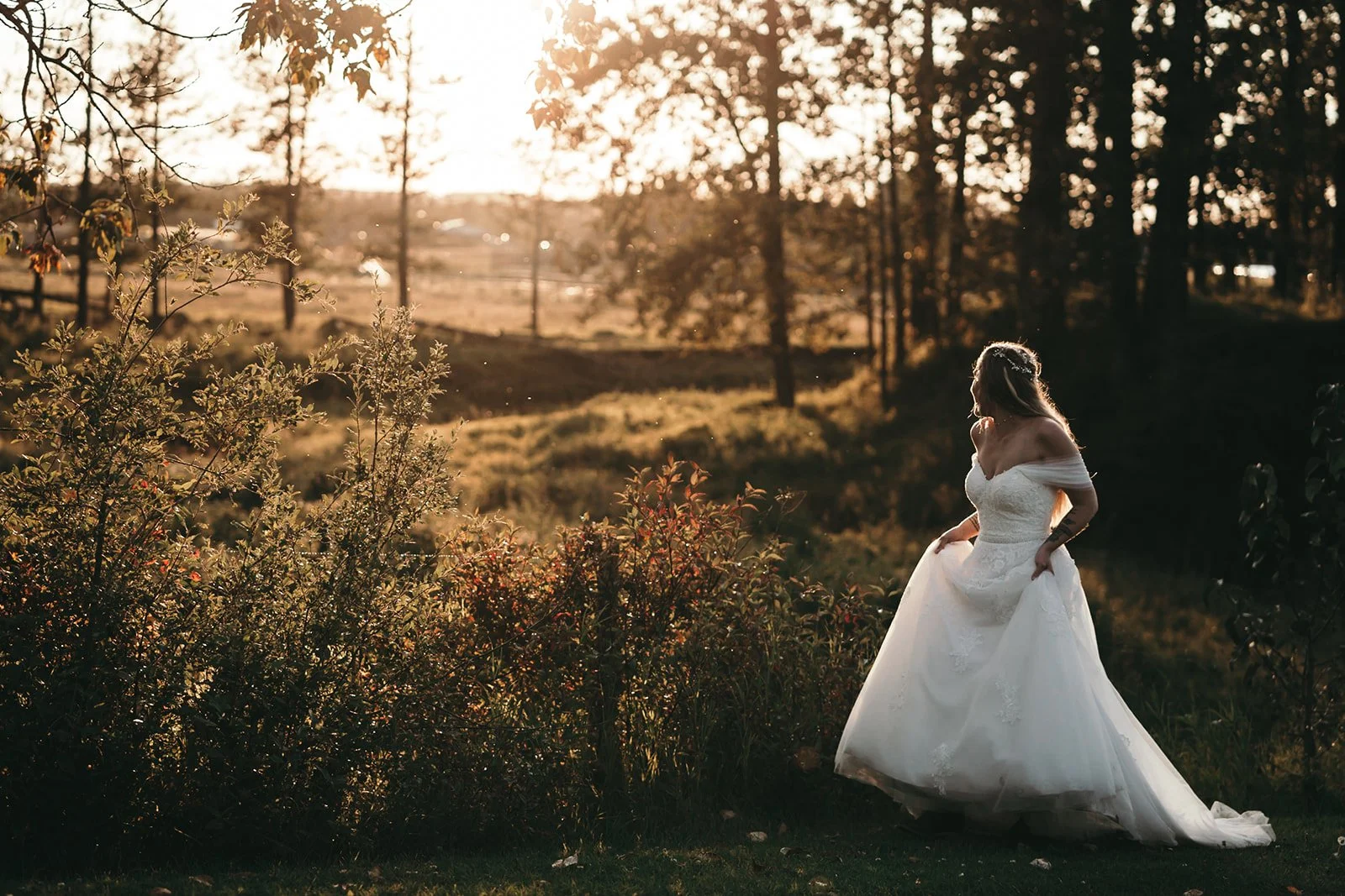 A bride enjoys a golden hour portrait surrounded by nature at Pine and Pond, showcasing the scenic beauty that makes outdoor weddings so memorable.