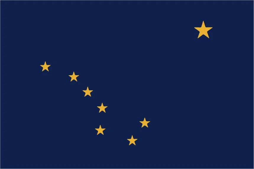 The flag of Alaska featuring a dark blue background with eight gold stars, one large and seven smaller, representing the Big Dipper and the North Star.
