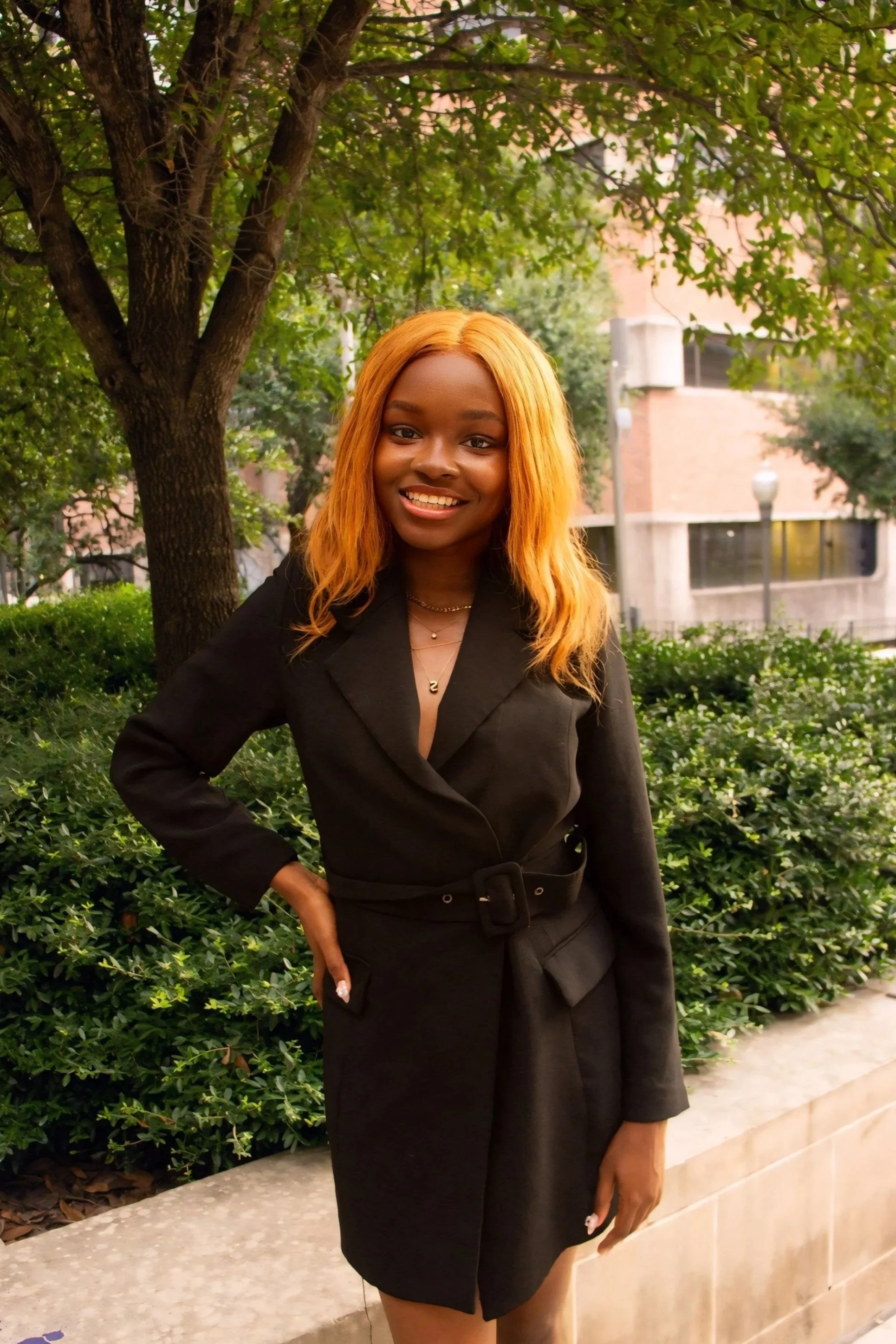 Woman with long black hair and beige top standing indoors