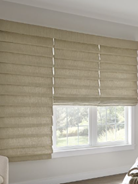 Beige window blinds covering a window with a view of trees outside