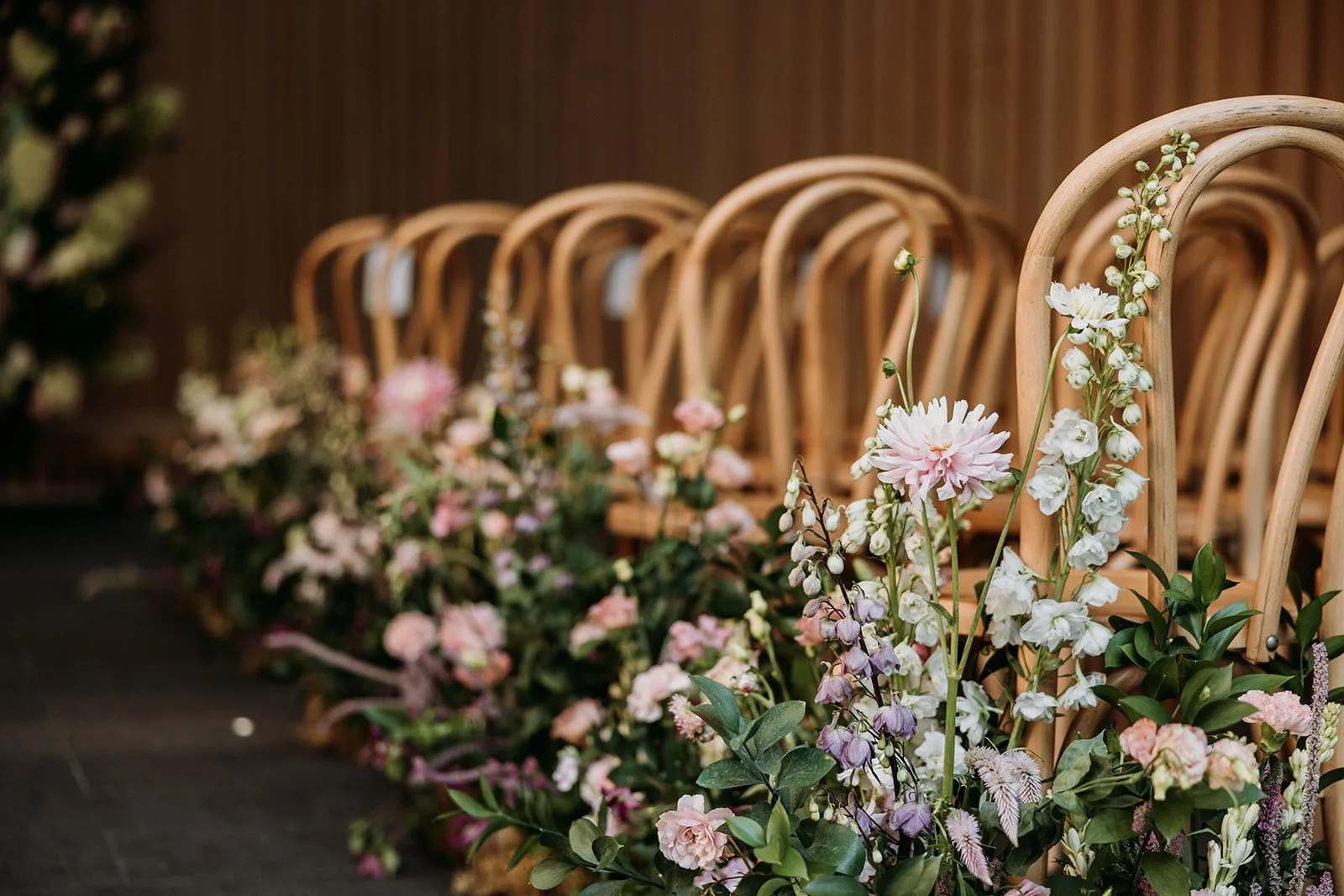 Ceremony aisle florals at the Audain Art Museum in Whistler, designed by Bliss for a modern, elegant wedding.