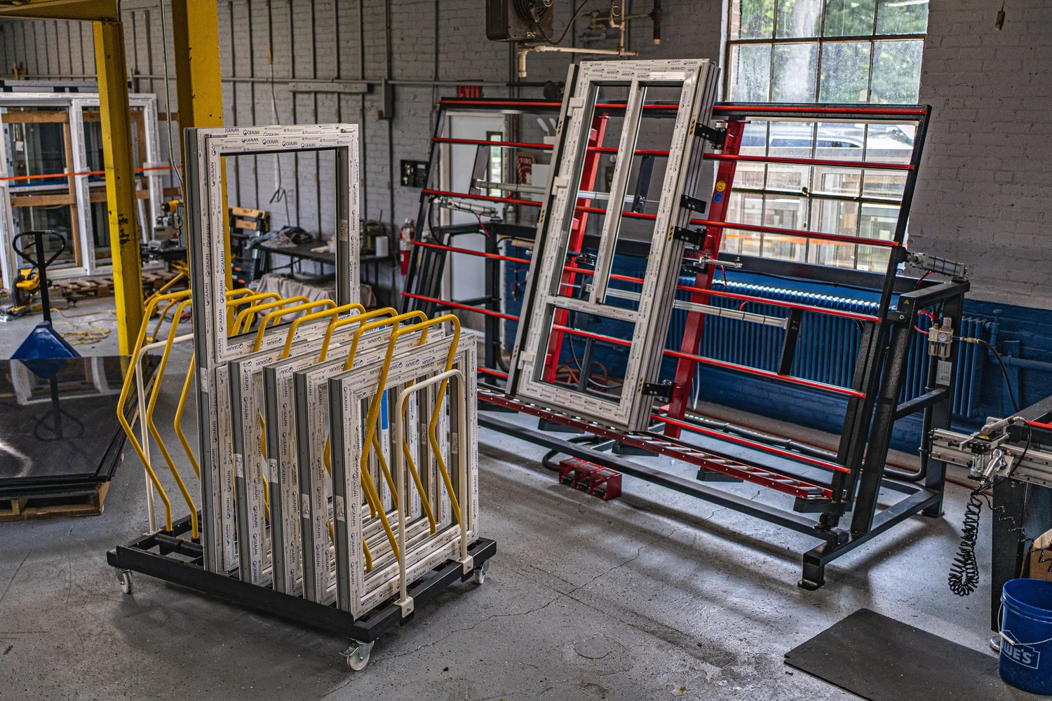 Finished GALAA window units racked on the shop floor at the Plainville factory