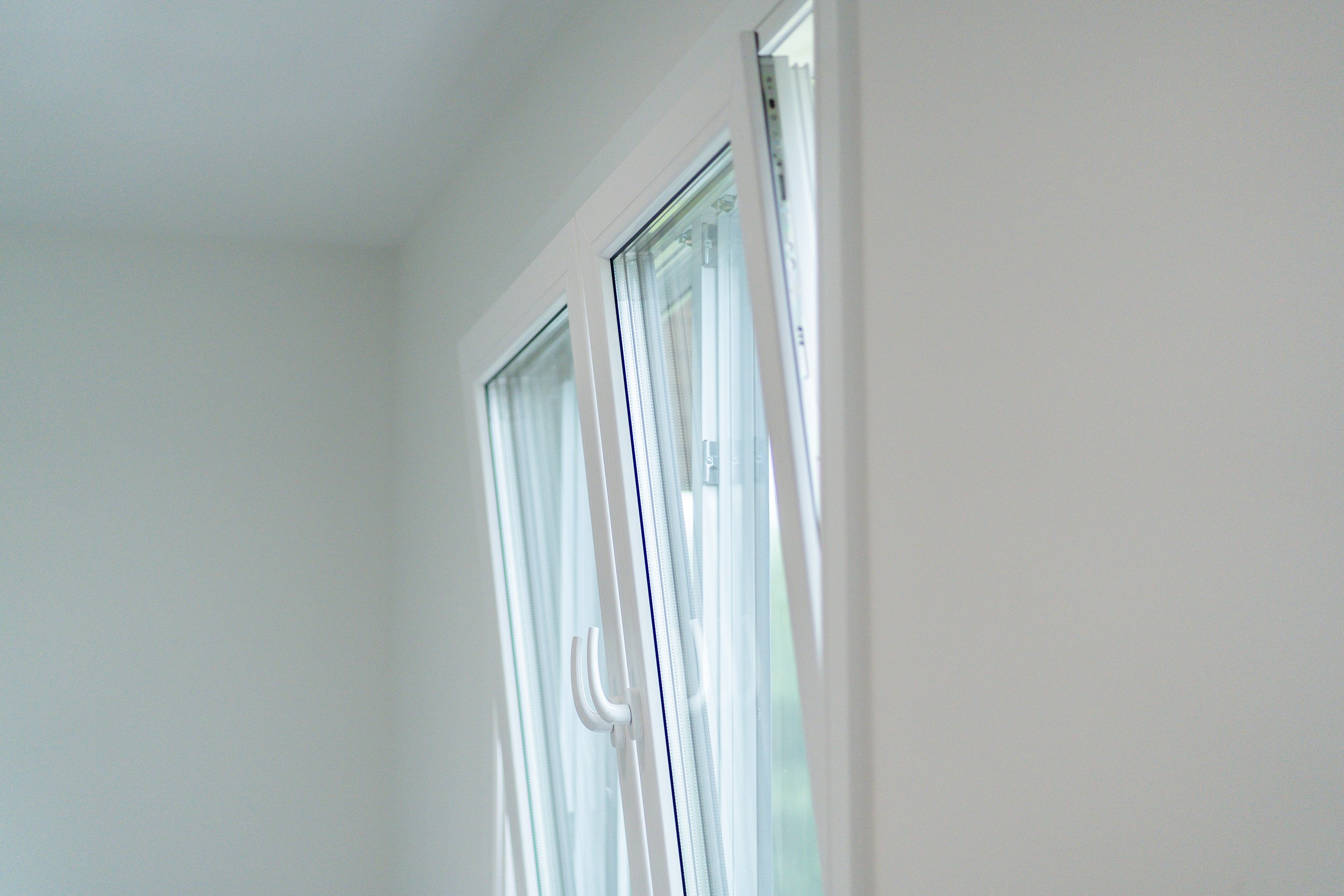 Interior view of tilt-turn window sash open, showing WINKHAUS multi-point locking hardware