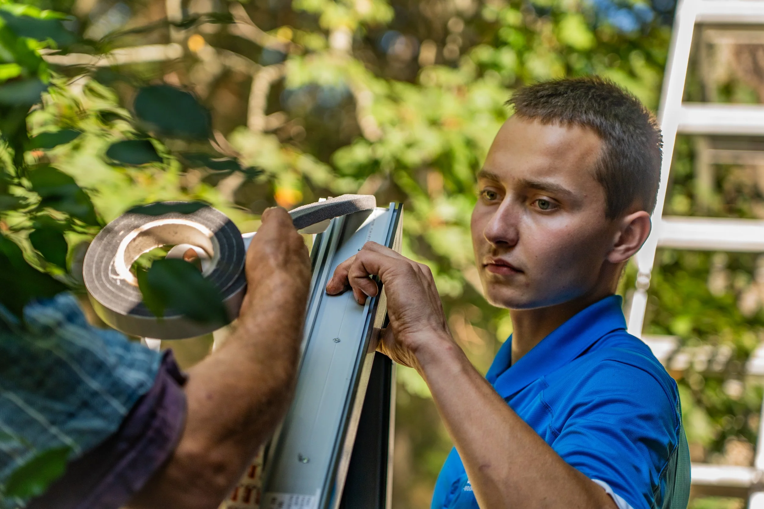 Galaa Windows technician fitting weatherstrip seal on high-performance uPVC window frame replacement