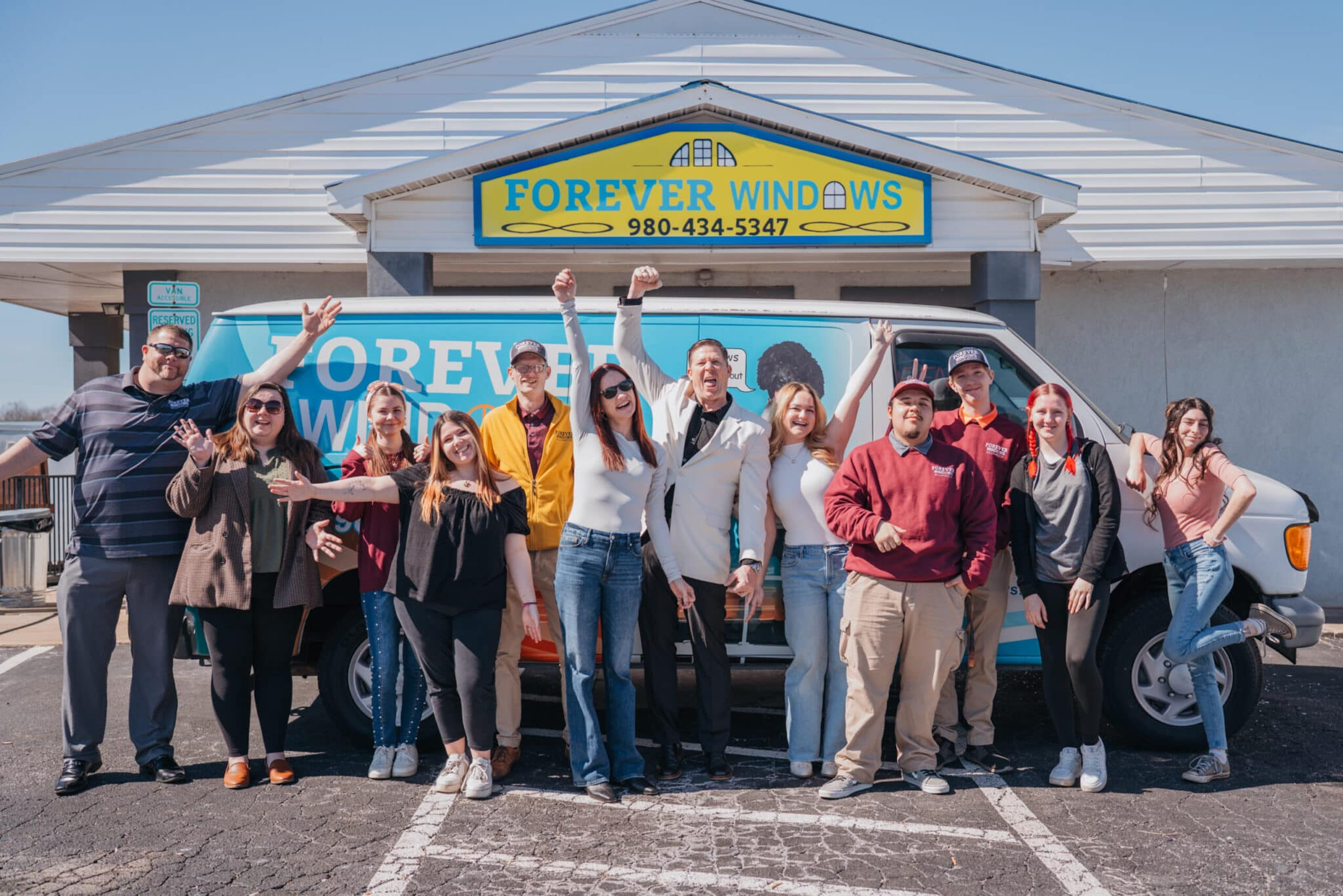 Excited group of sales people celebrating new revenue records with immersive sales management services from Pivotal.