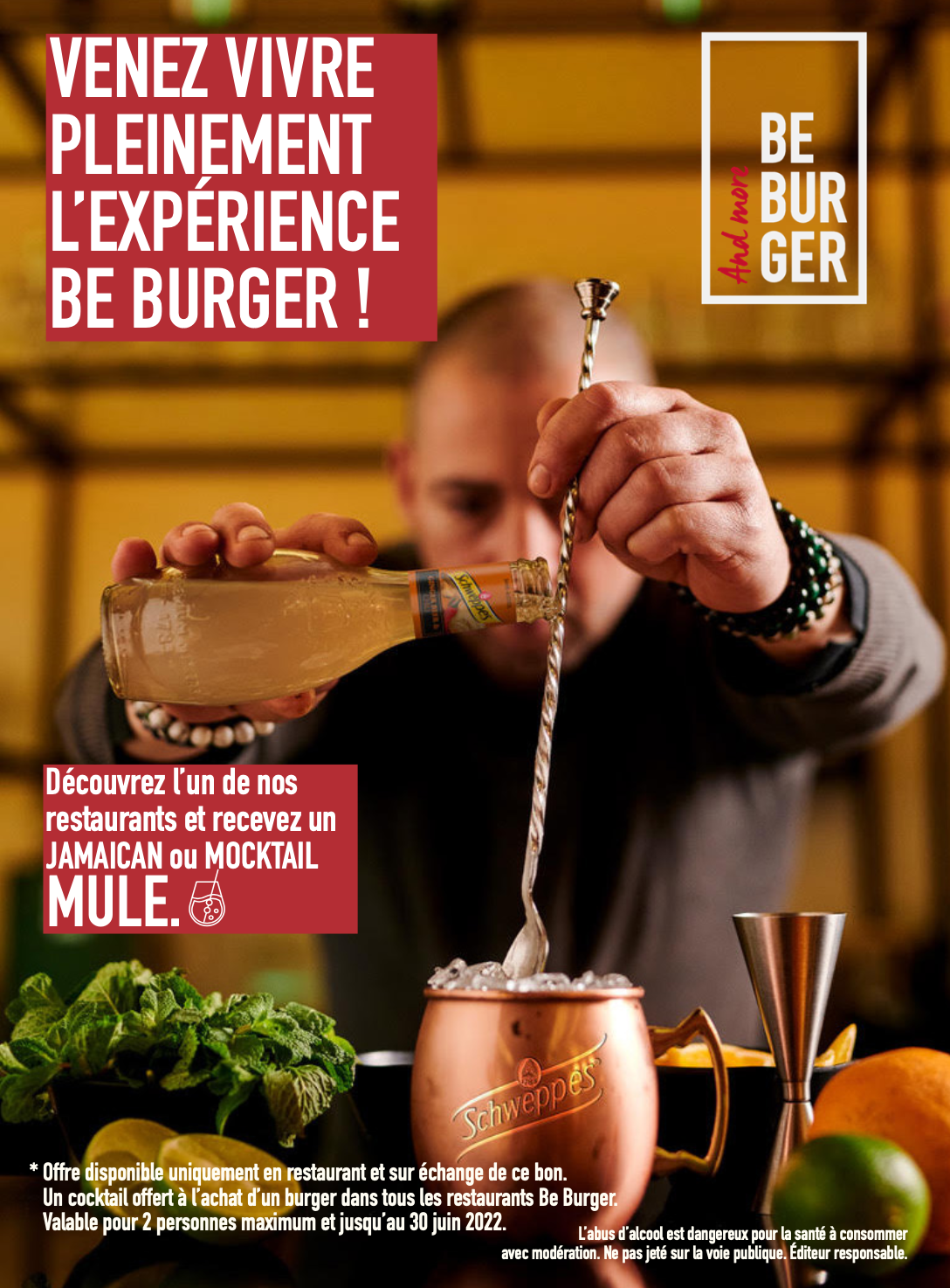 A person holding a bottle of liquor and pouring it into a cocktail shaker at a bar counter, with a background of yellow walls and various bartending tools and ingredients.