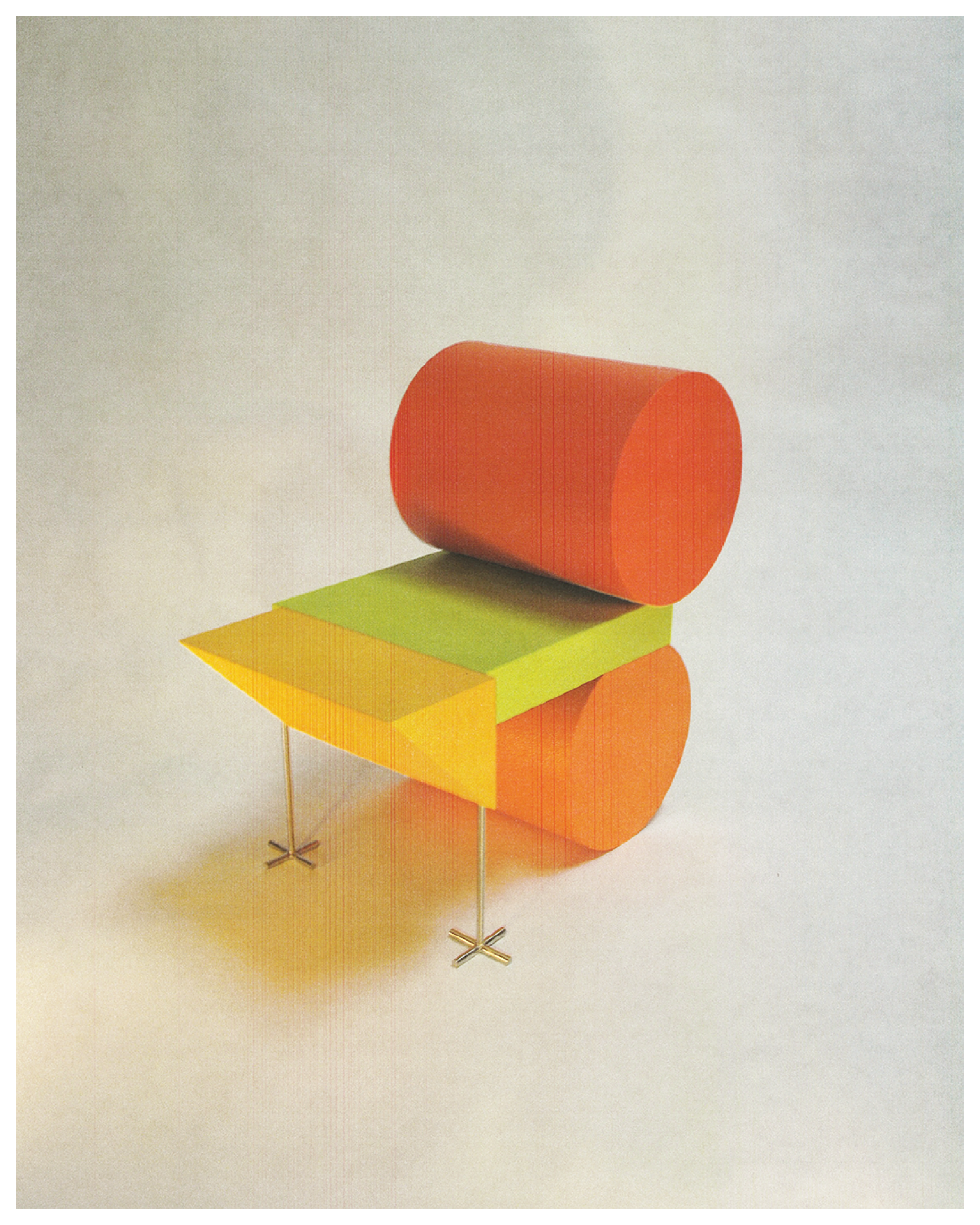 Colorful geometric modern chair with a red cylindrical backrest, green seat, and yellow seat extension supported by thin metal legs.