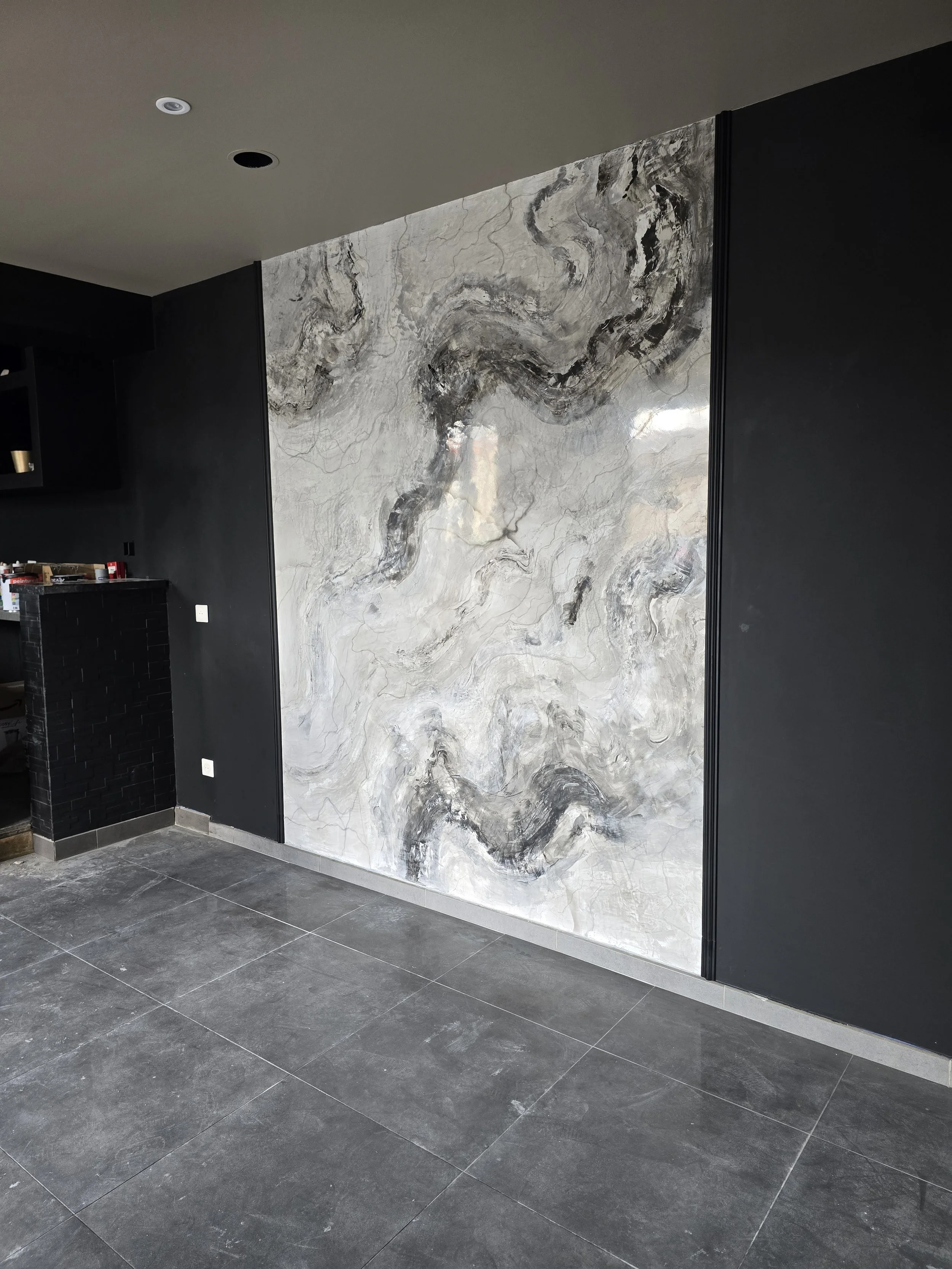 Mur en pierre de style marbre avec veines roses, blanc, gris et touches d'or