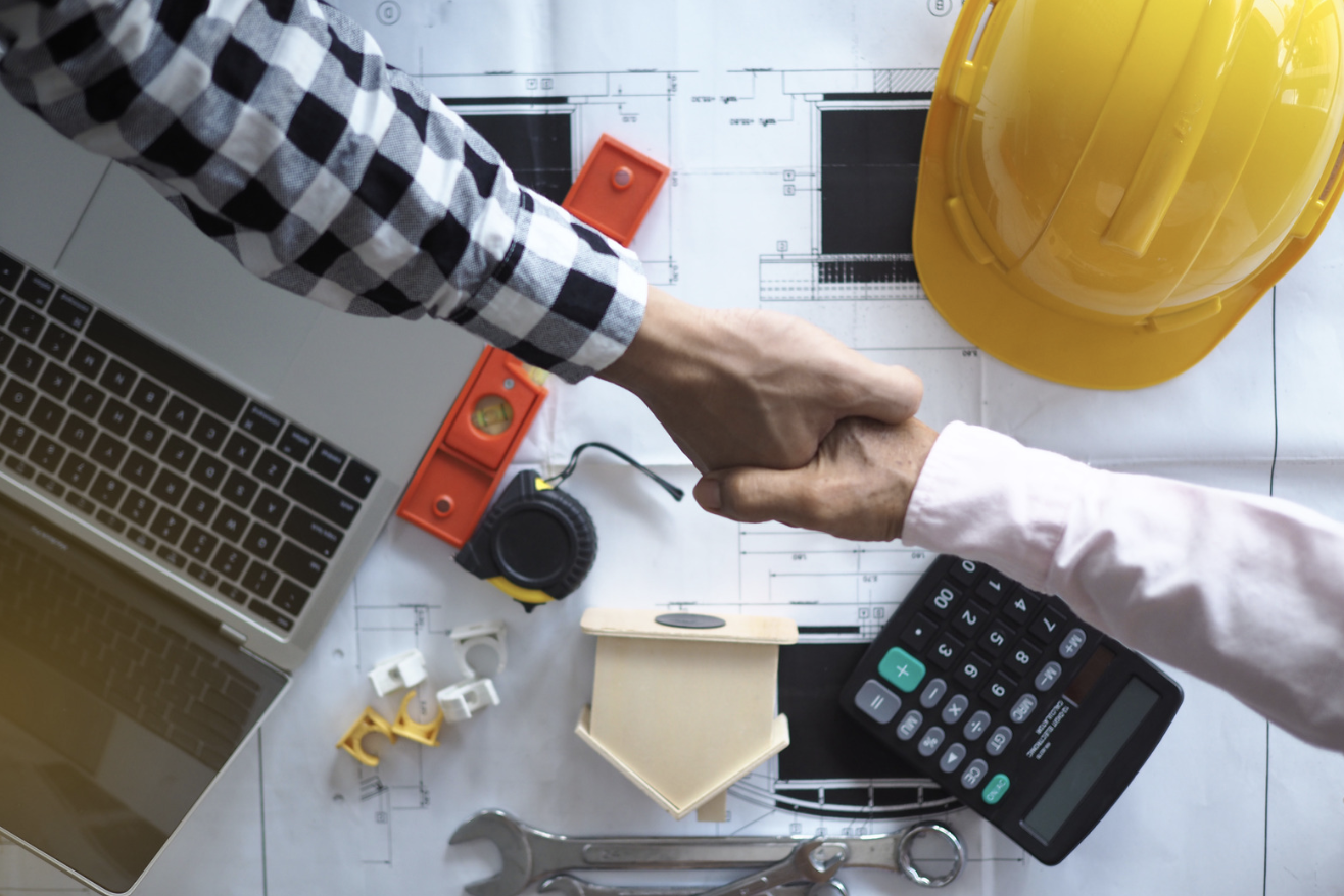 builder and contractor shake hands on building deal