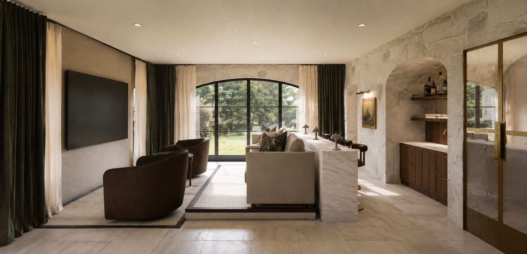Living room with beige tile flooring, a large window with curtains, a flat-screen TV on the wall, two dark brown chairs, a beige sofa with decorative pillows, a white marble partition, and a bar area with wooden cabinets and shelves.