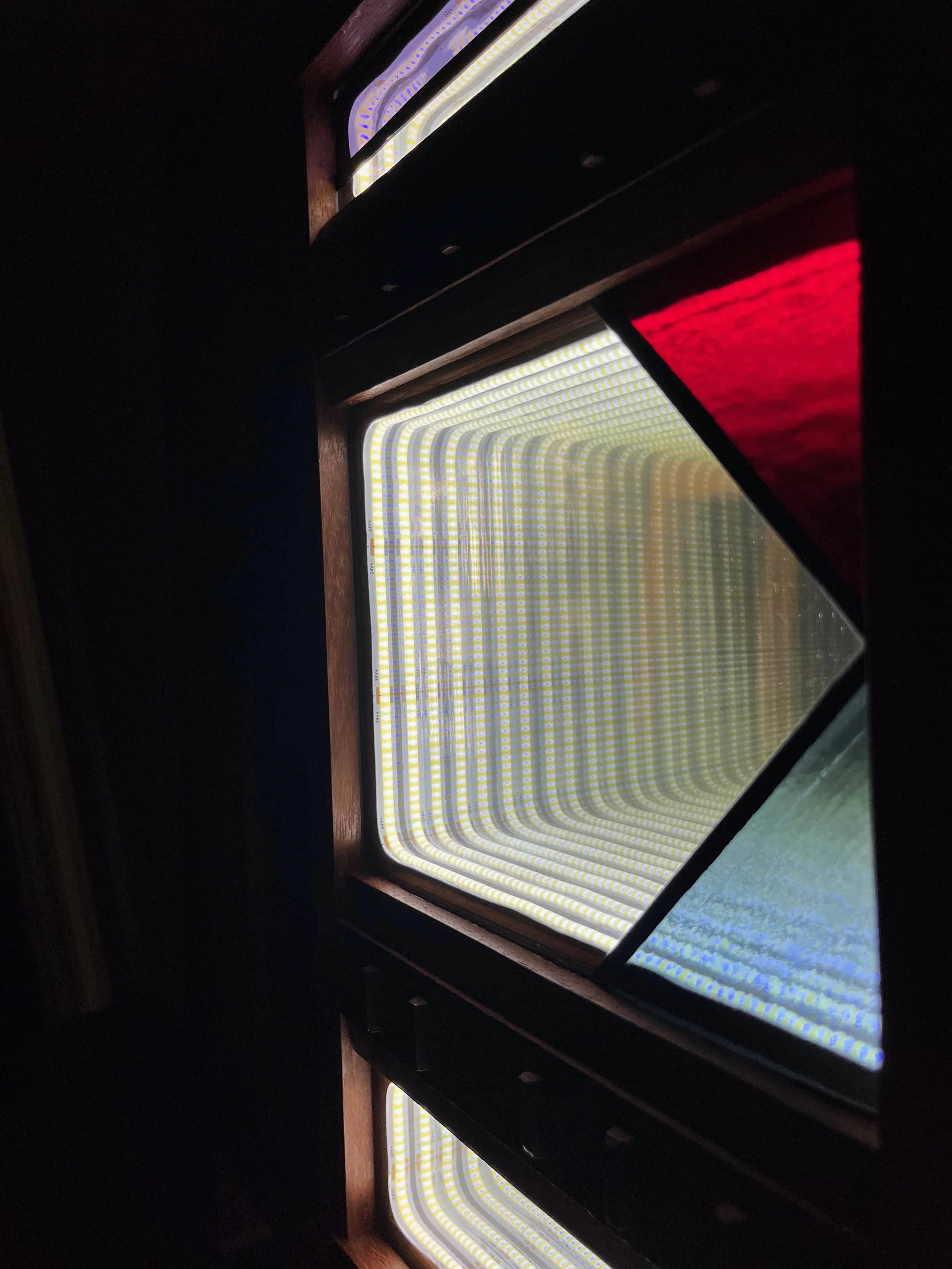 Close up of infinity mirror with stained glass panels