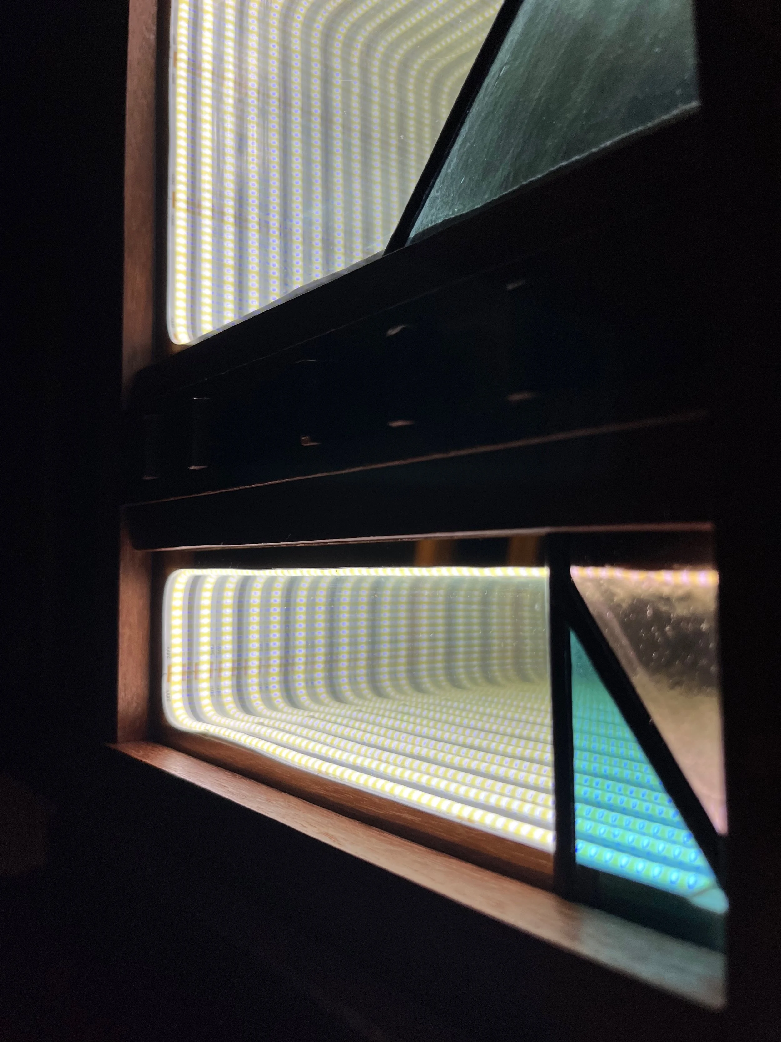 Close up of infinity mirror with stained glass panels