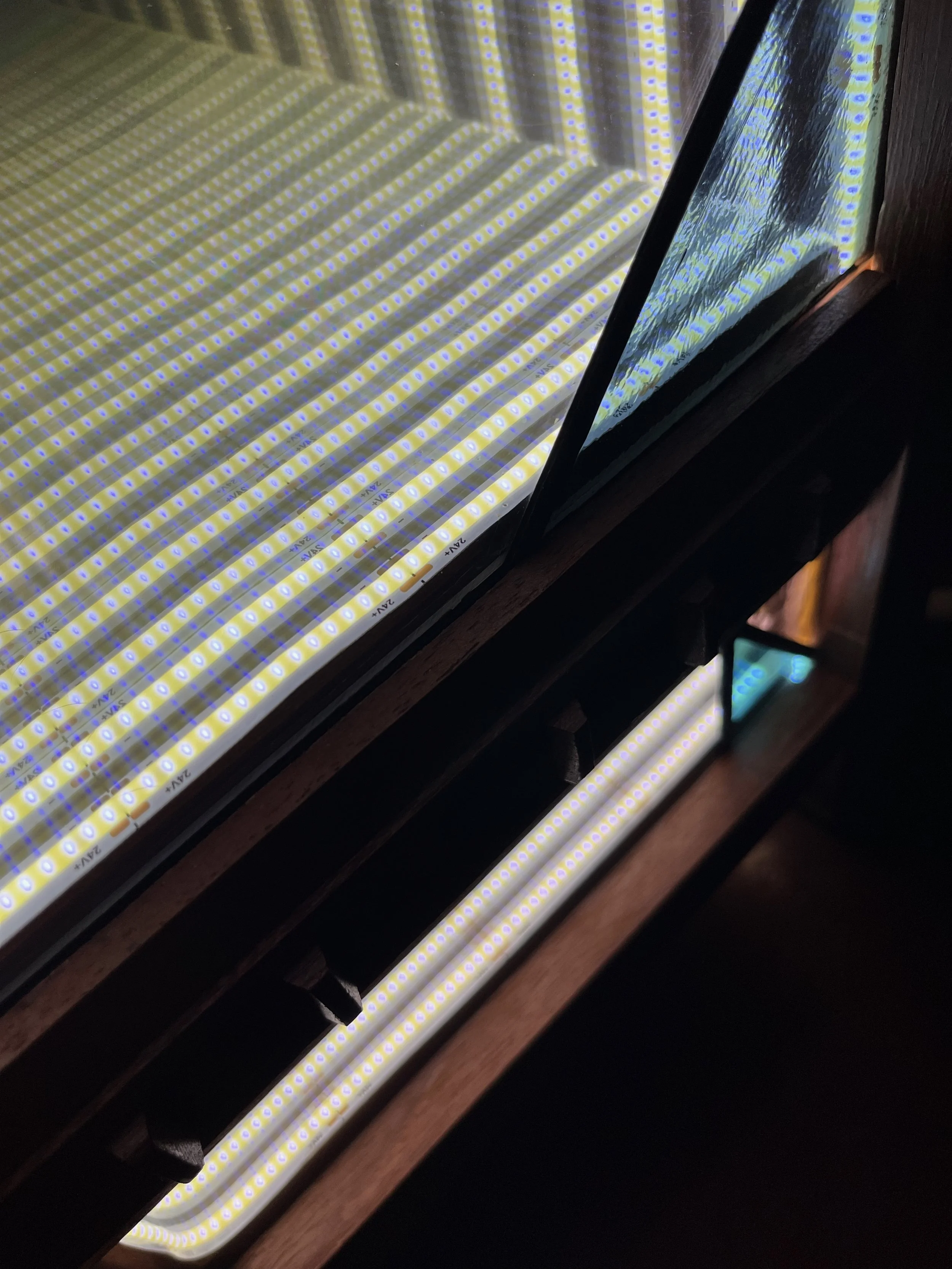 Close up of infinity mirror with stained glass panels