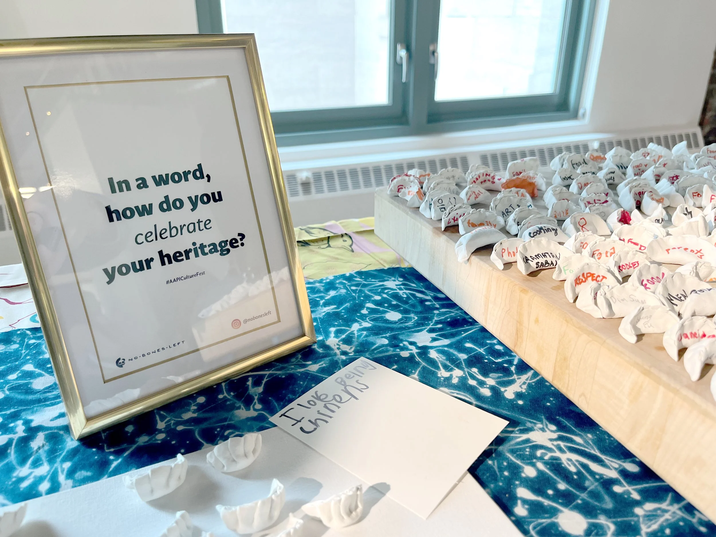 Close up image of project including frame with "In a word, how you celebrate your heritage" and dumplings with participant answers written on them