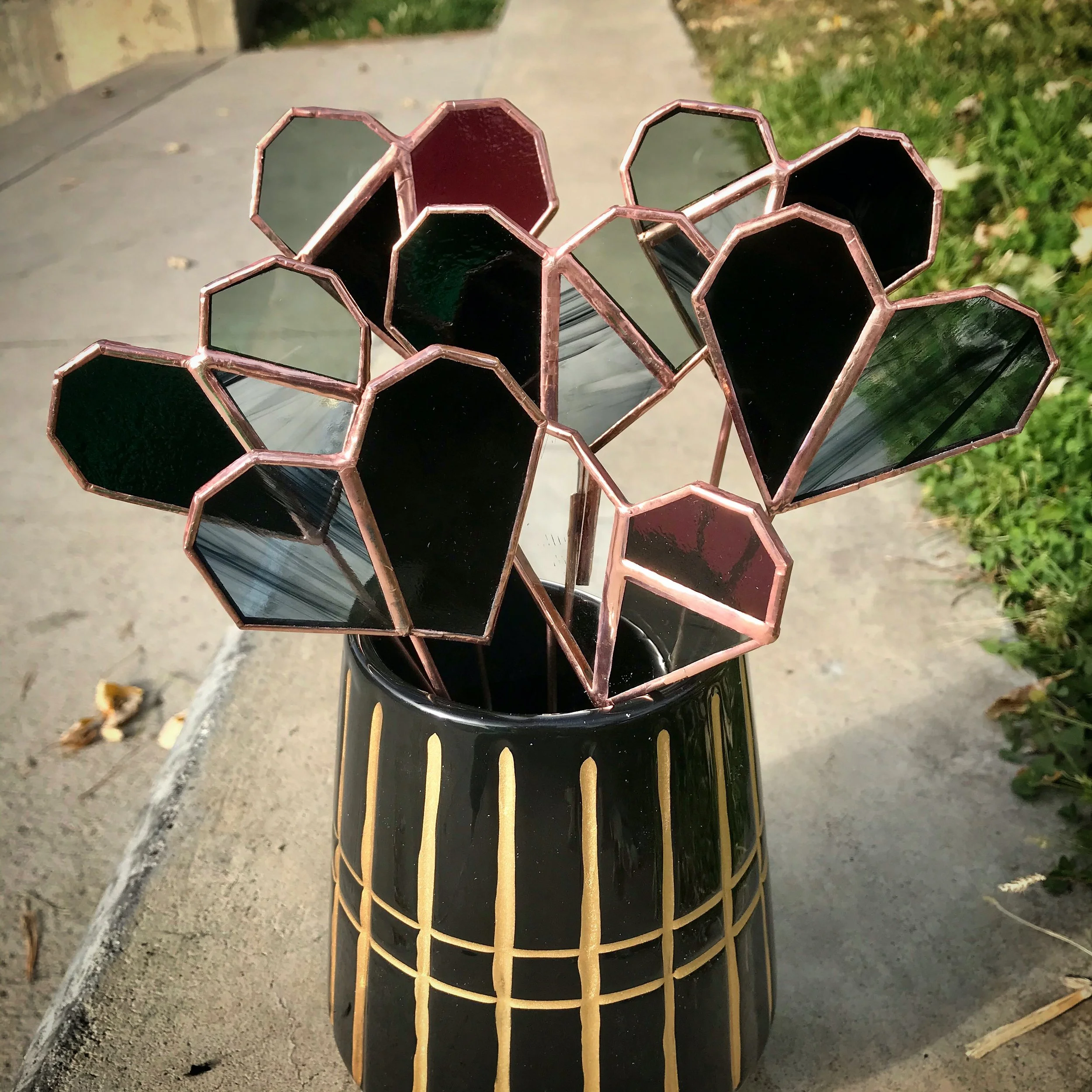 Stained glass heart sculptures in vase