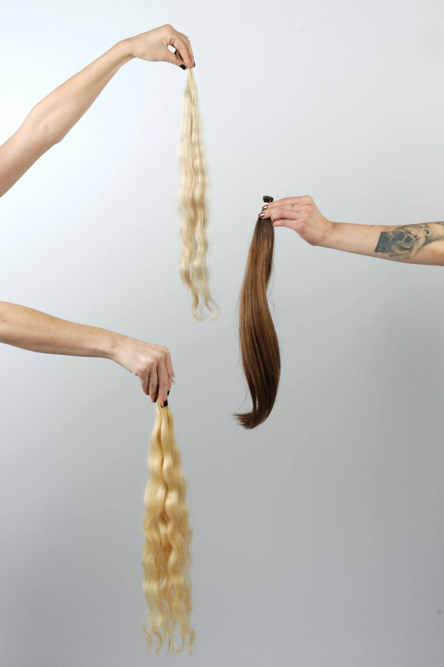 Weft hair extensions being installed for a seamless, natural-looking result