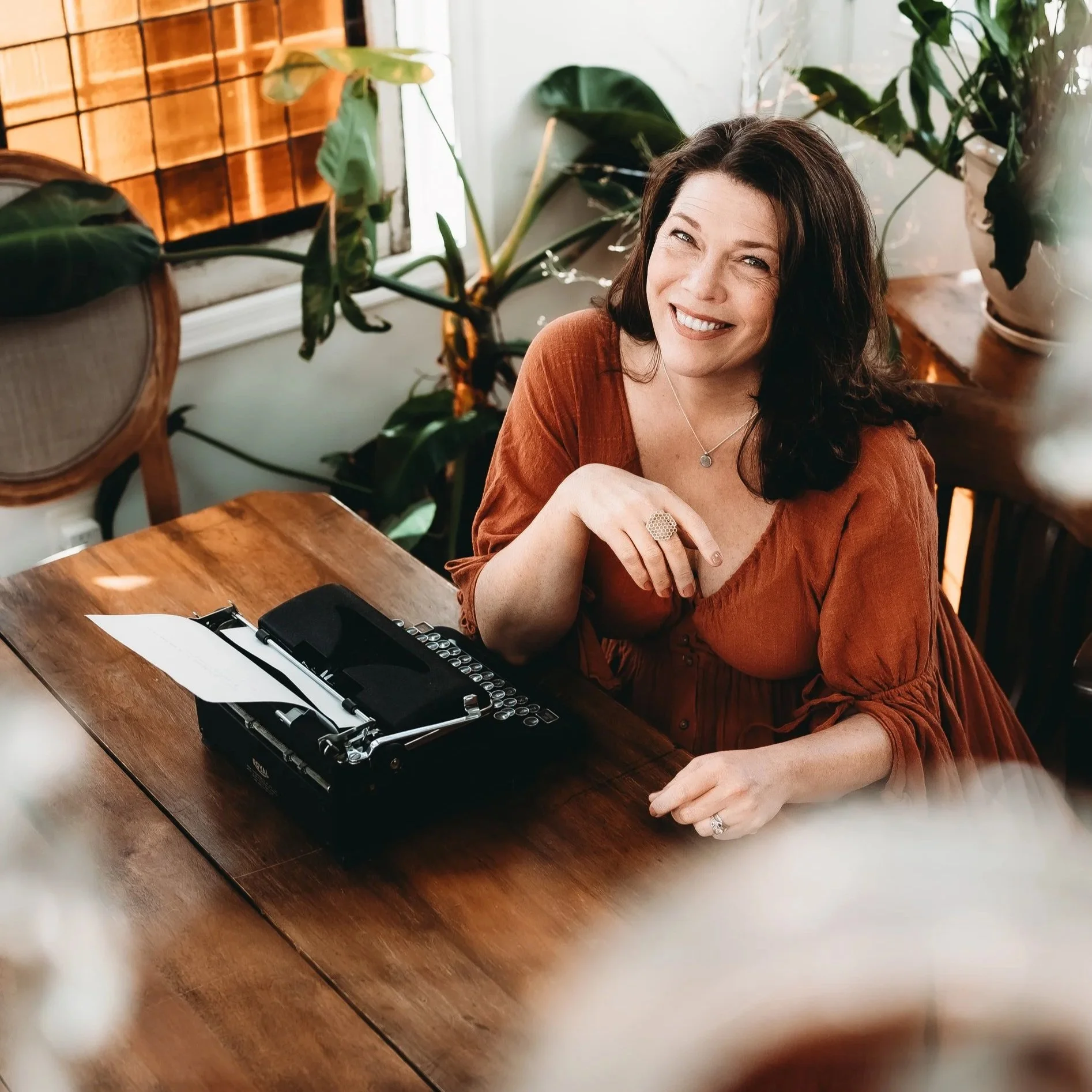 Historical novelist Christy Tallamy sitting at her typewriter