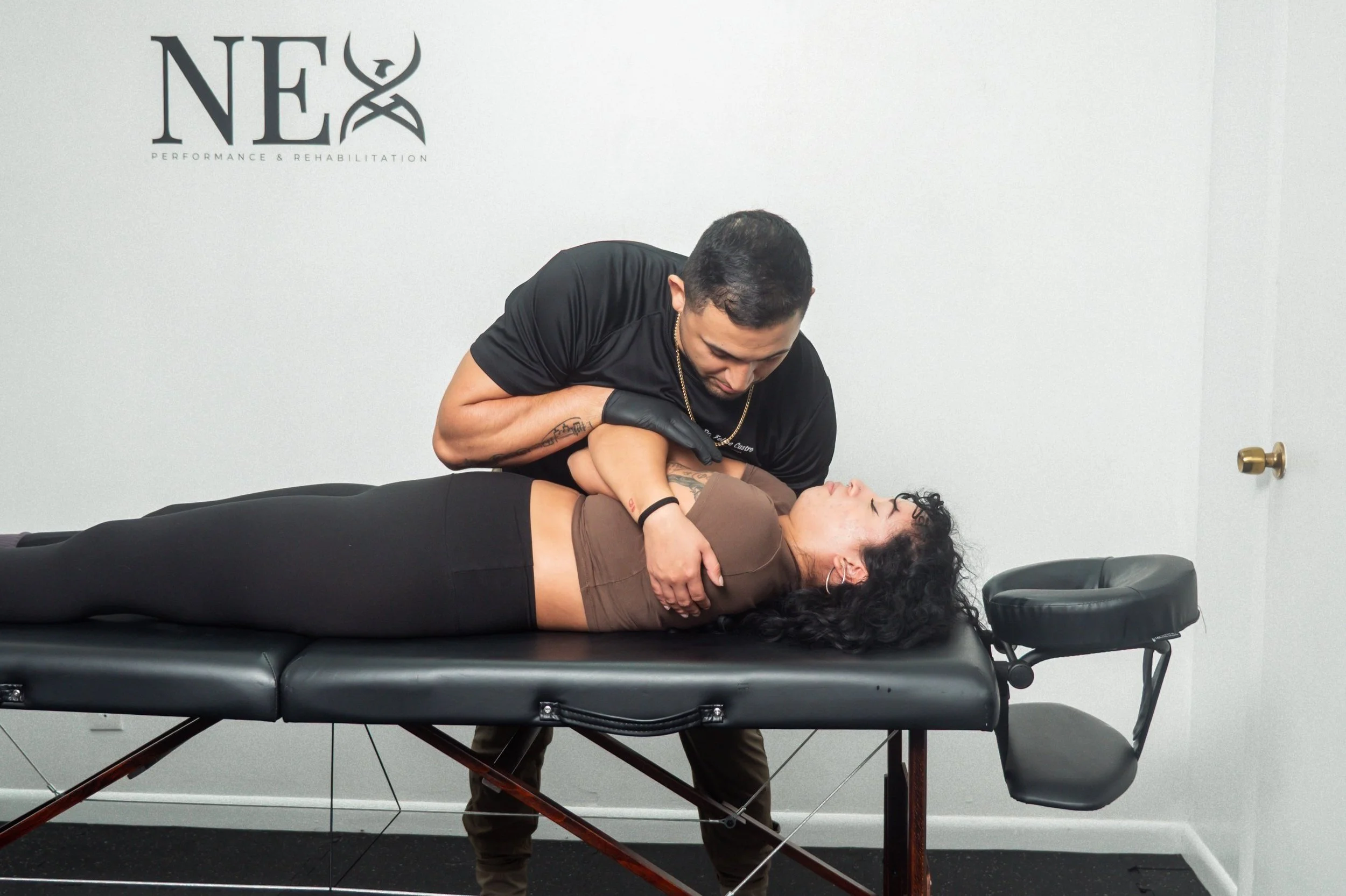 dr. felipe castro performing a spinal manipulation to improve mobility and reduce pain at nex performance and rehab, north miami beach