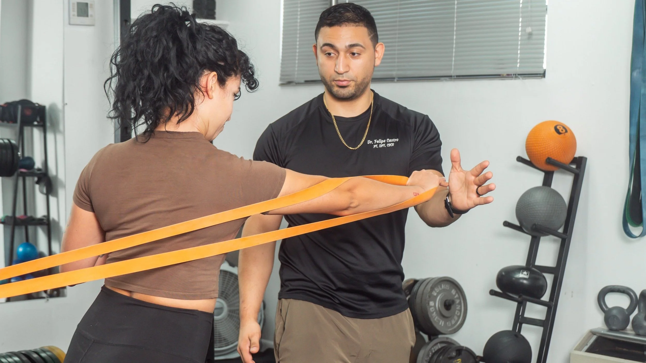 dr.felipe castro coaching an active adult pressing mechanics at nex performance & Rehab, north miami beach
