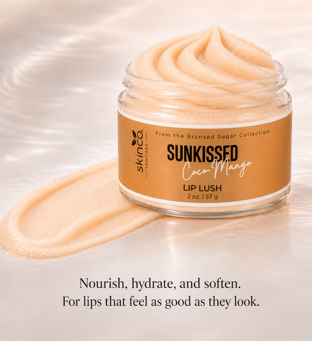 A jar of Skinfeed Sunkissed Coco Mango Lip Lush with a swirled lip balm on a reflective surface, with soft lighting and a blurred background. Text below states: 'Nourish, hydrate, and soften. For lips that feel as good as they look.'