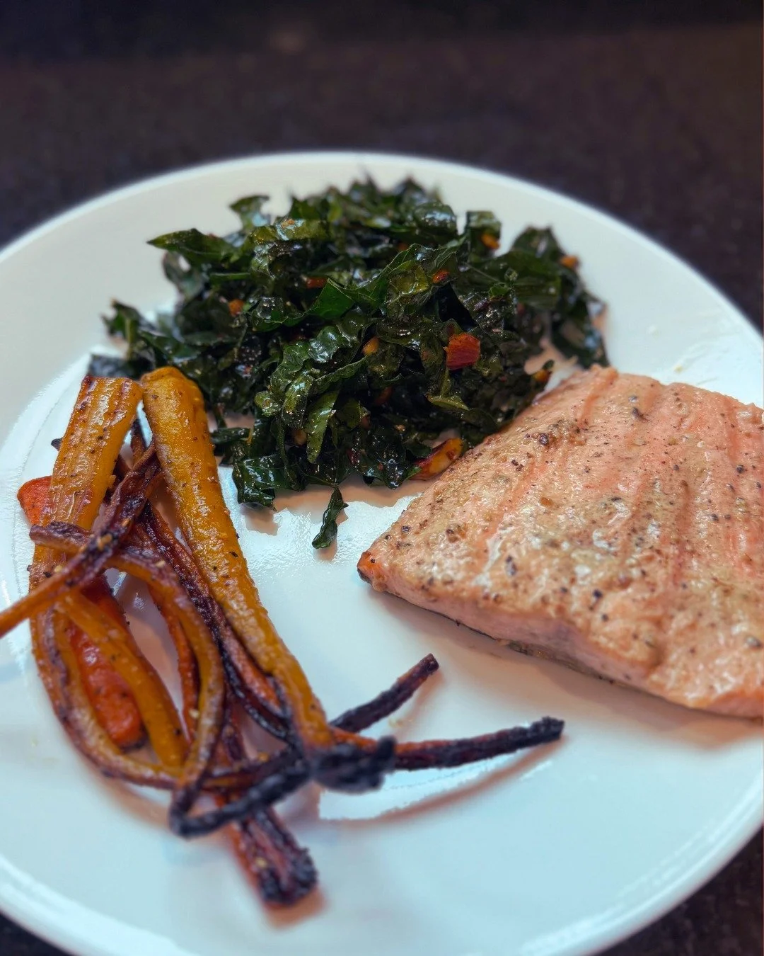 Roasted za'atar carrots and spicy kale salad with broiled salmon &mdash; Homemade by Annie. 

Link in bio to book!