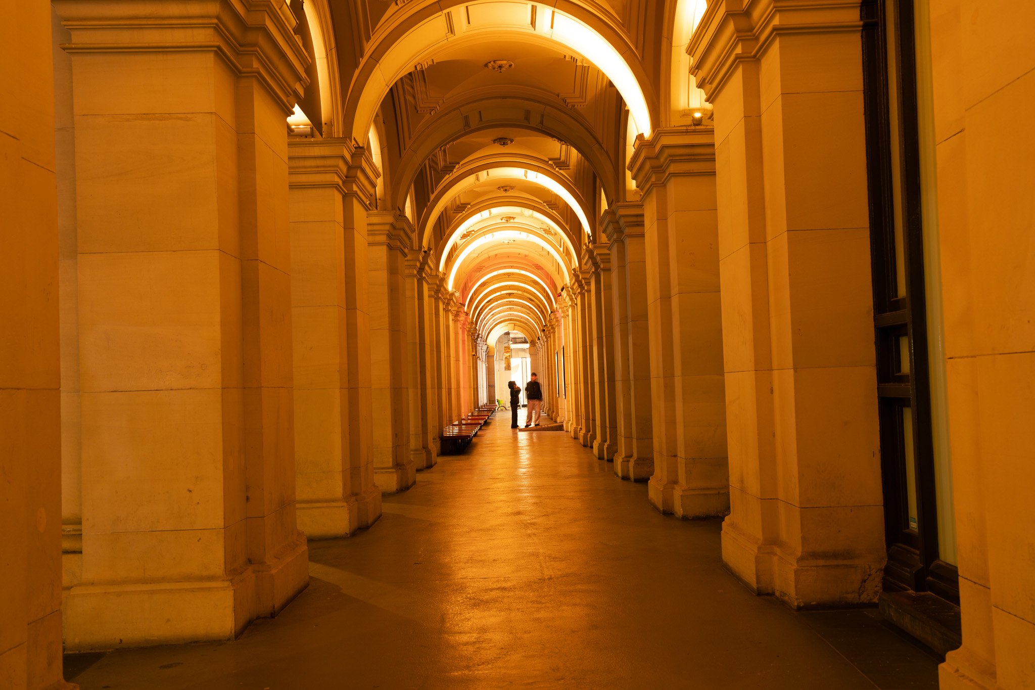 the light at GPO Melbourne colonnade with 2 people admiring it