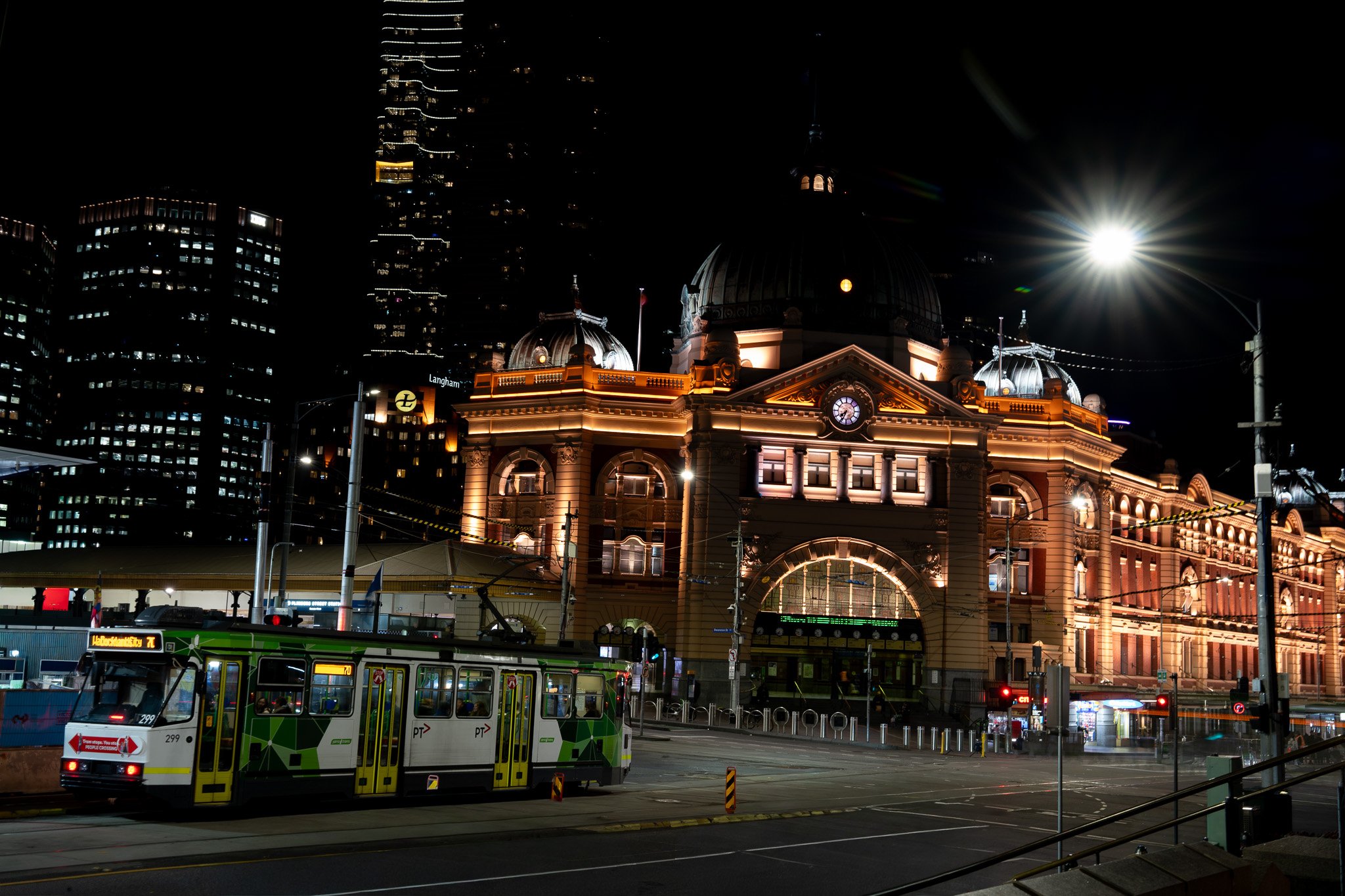 Flinders Street Station at night with the tram
