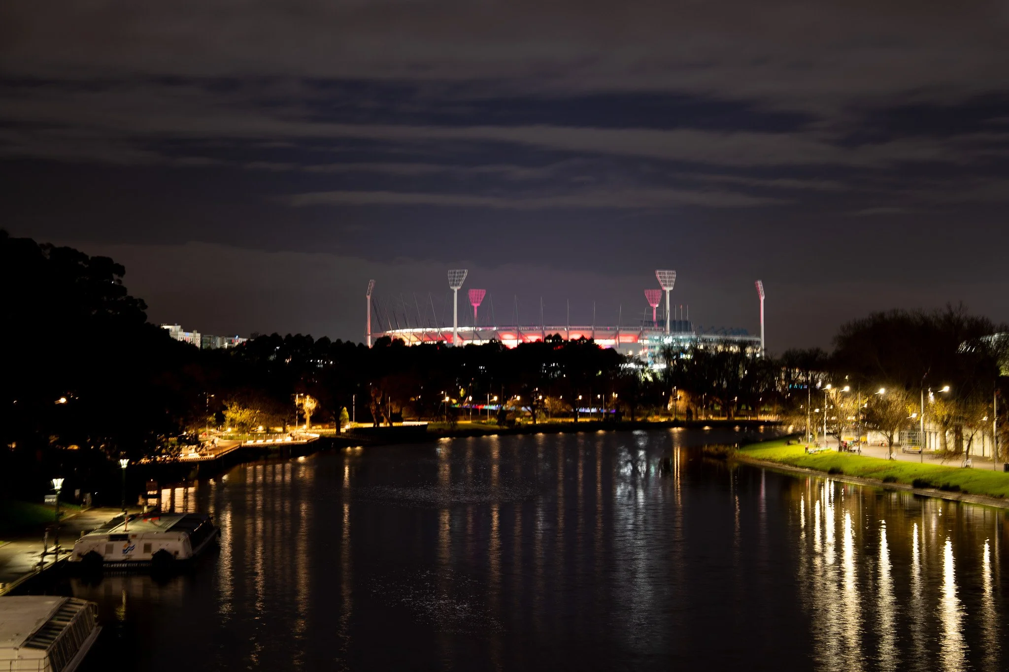 Melbourne Cricket Ground at night with red light glowing from within
