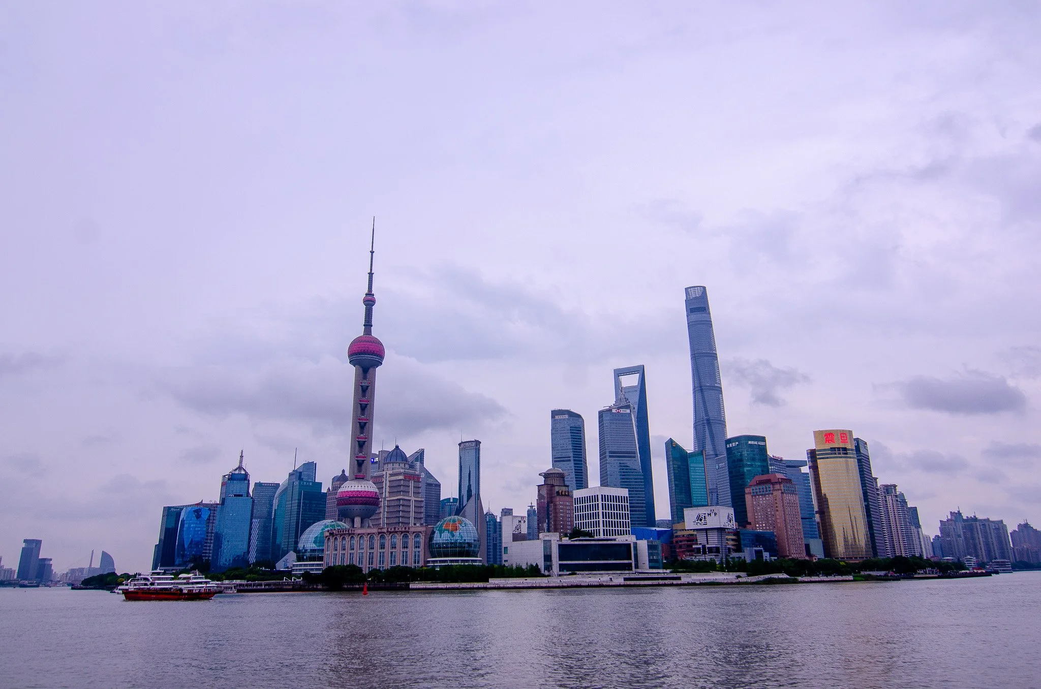 Skyline of Shanghai with the Oriental Pearl Tower and tall skyscrapers along the Huangpu River.