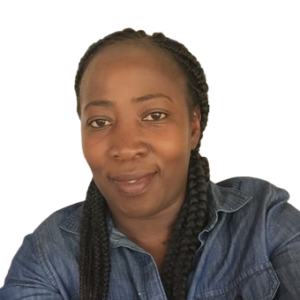 Close-up of a woman with braided hair wearing a denim shirt, smiling slightly, against a plain background.