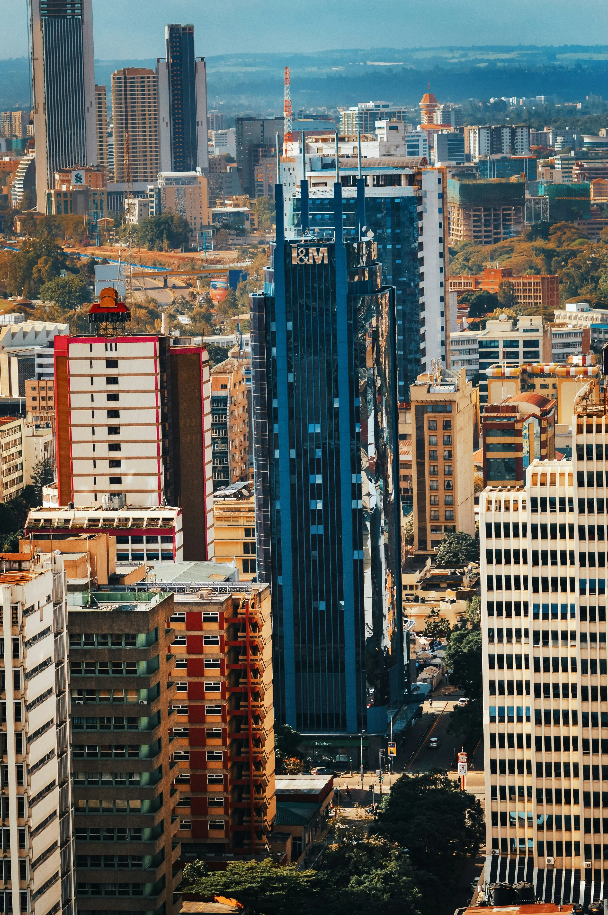 A city skyline with tall buildings, including one with a