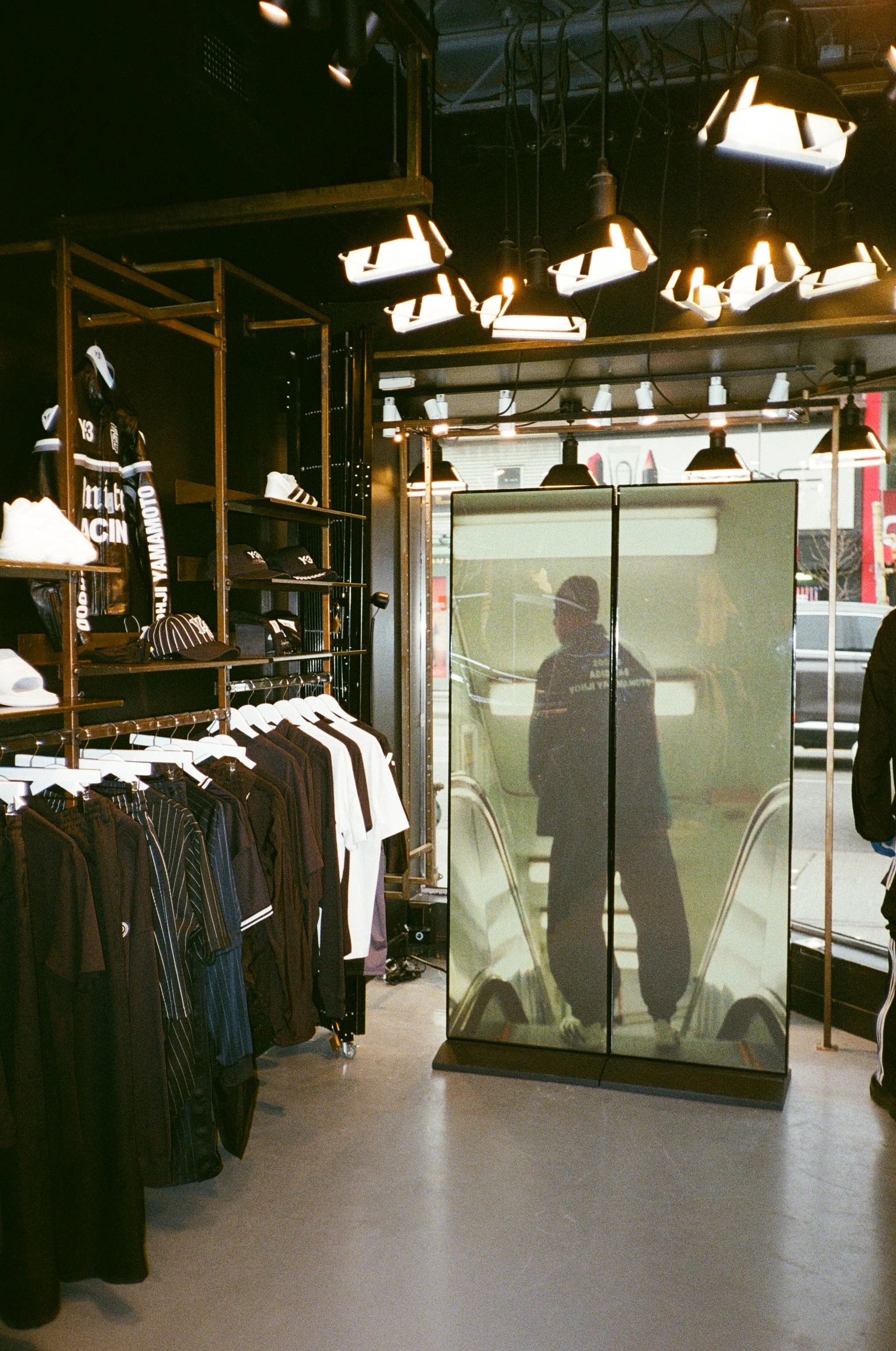 An in-store photo of the Adidas Y-3 fashion film and retail display.