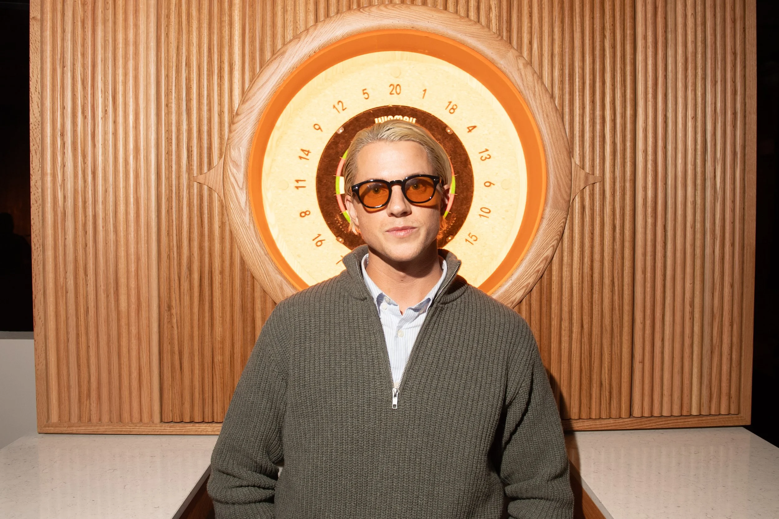 VIP guest, Tyler Reaume, at the MNTD launch event hosted by Public/Realm; this artistic shot has Tyler posed in front of a dart board, as though there's an aura around his head