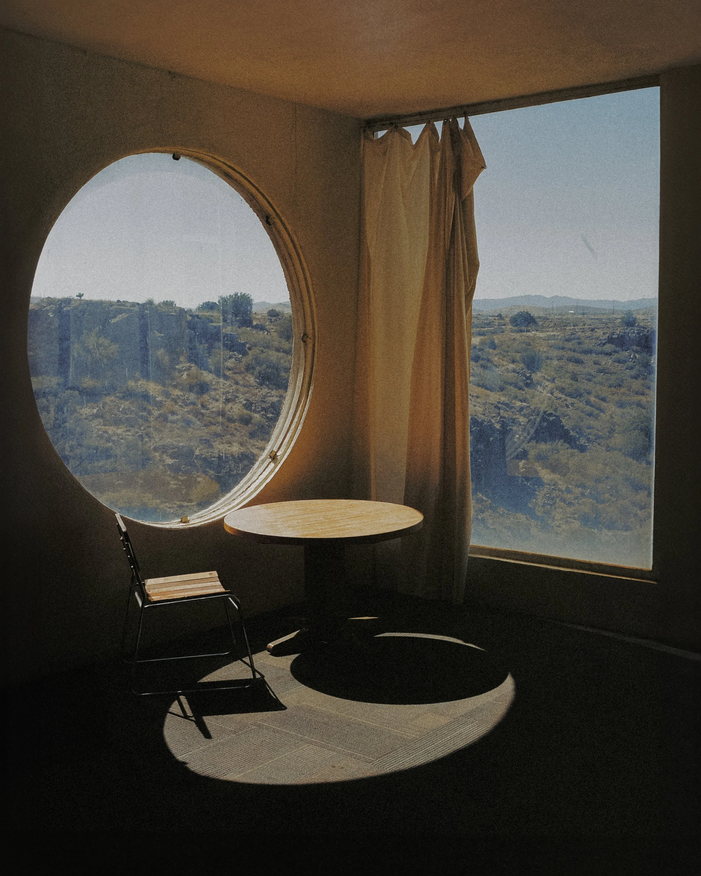 An interior photo showcasing the design of  Arcosanti with a view of the valley outside the windows shot by photographer Kirk Lisaj for Public/Realm's tastemaker blog series