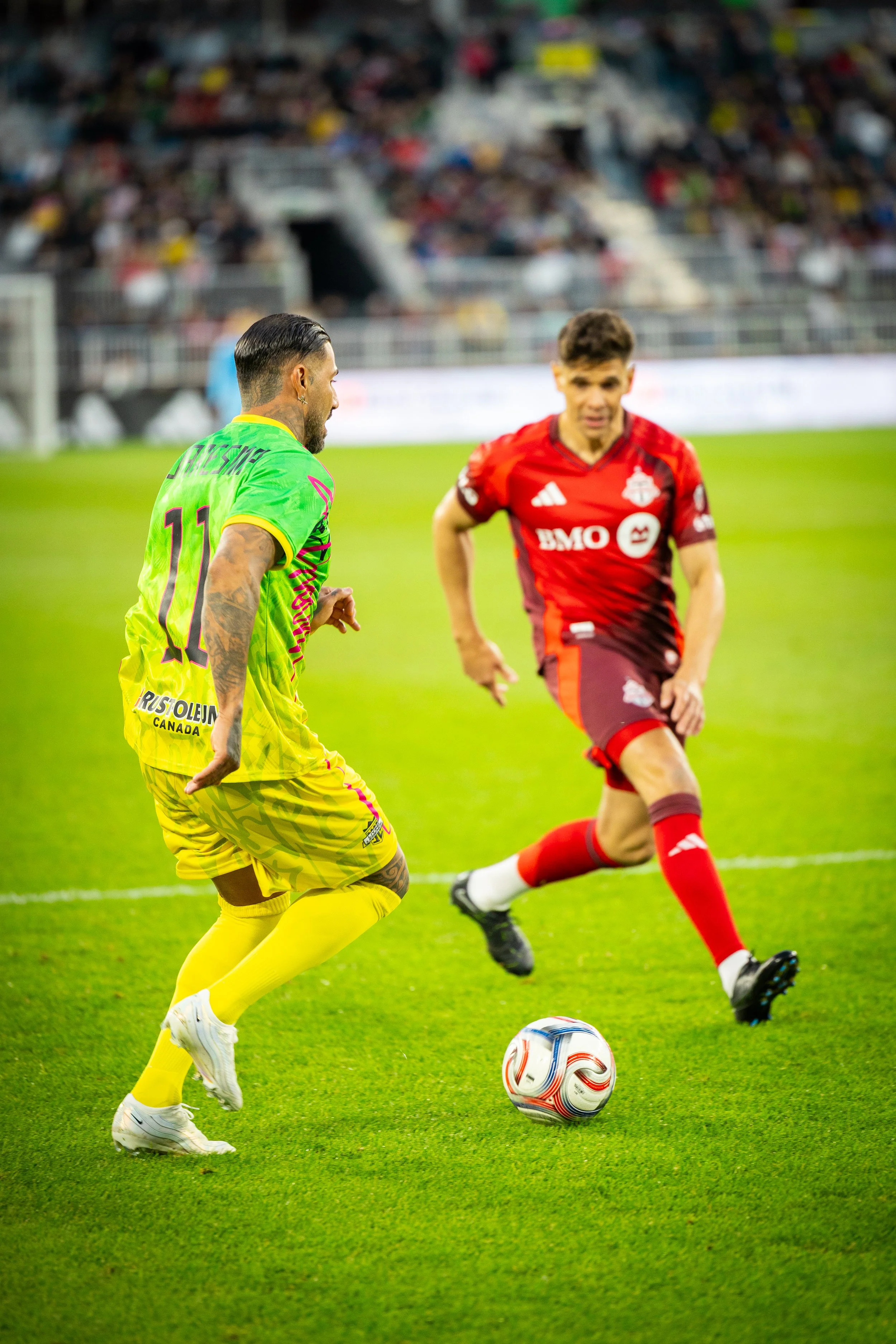 Soccer star, Quaresma in action against a TFC player at the Living Legends soccer match
