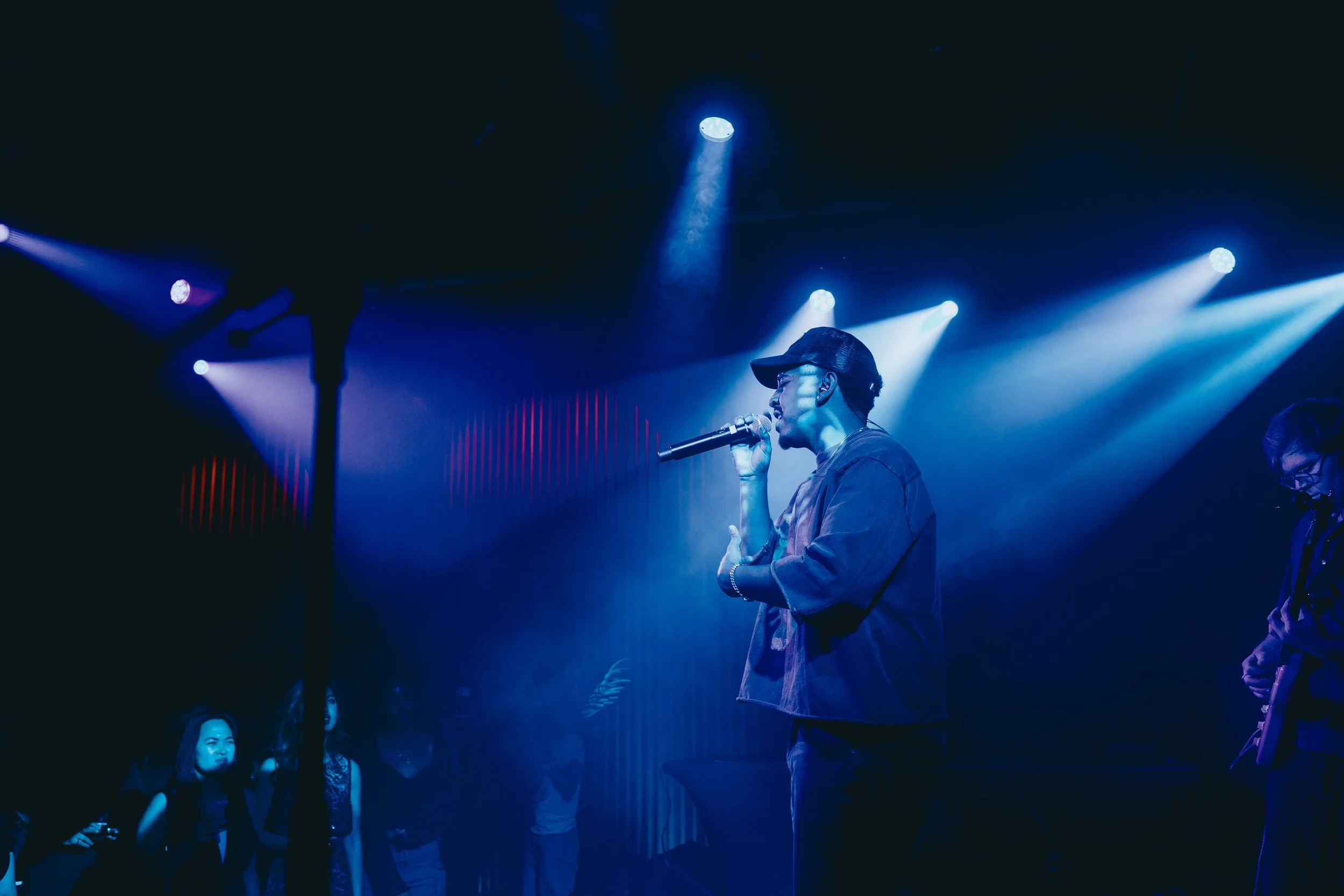 A performance photo of Universal Music's emerging artist, Andye Tamer, on-stage at Mi Campo's launch event at the Universal Music Headquarters hosted by Public/Realm