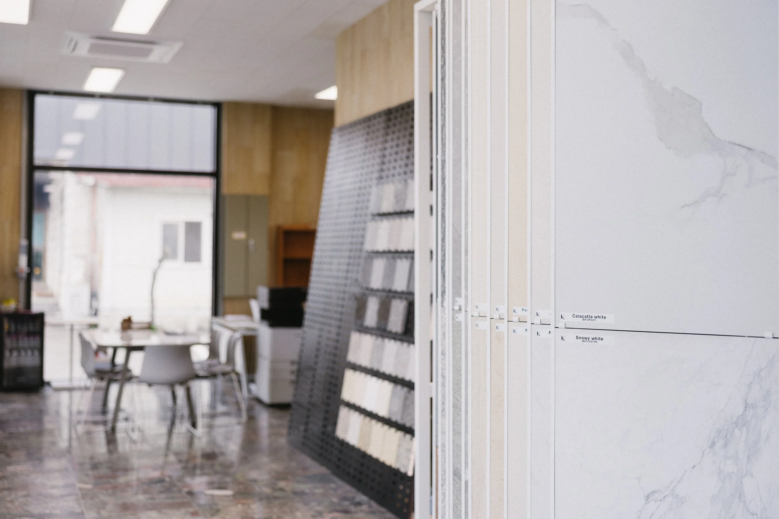 Close-up of green and grayish marble with natural veining patterns and textures.