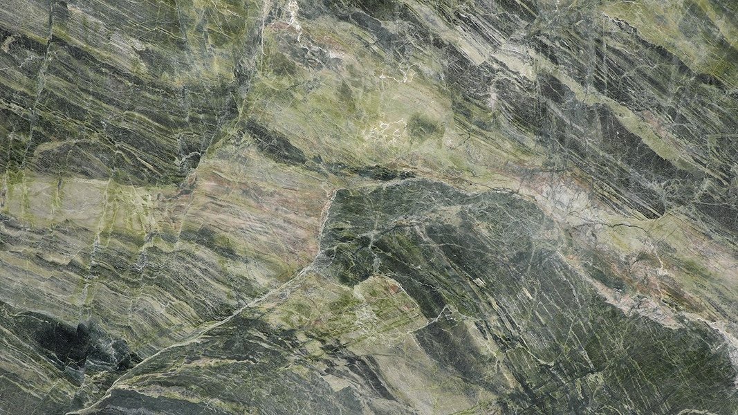 Close-up of green and grayish marble with natural veining patterns and textures.